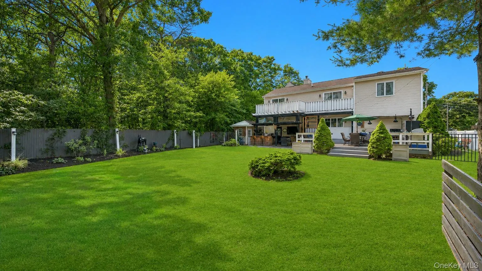 Expansive green lawn with mature perimeter trees Expansive green lawn with mature perimeter trees