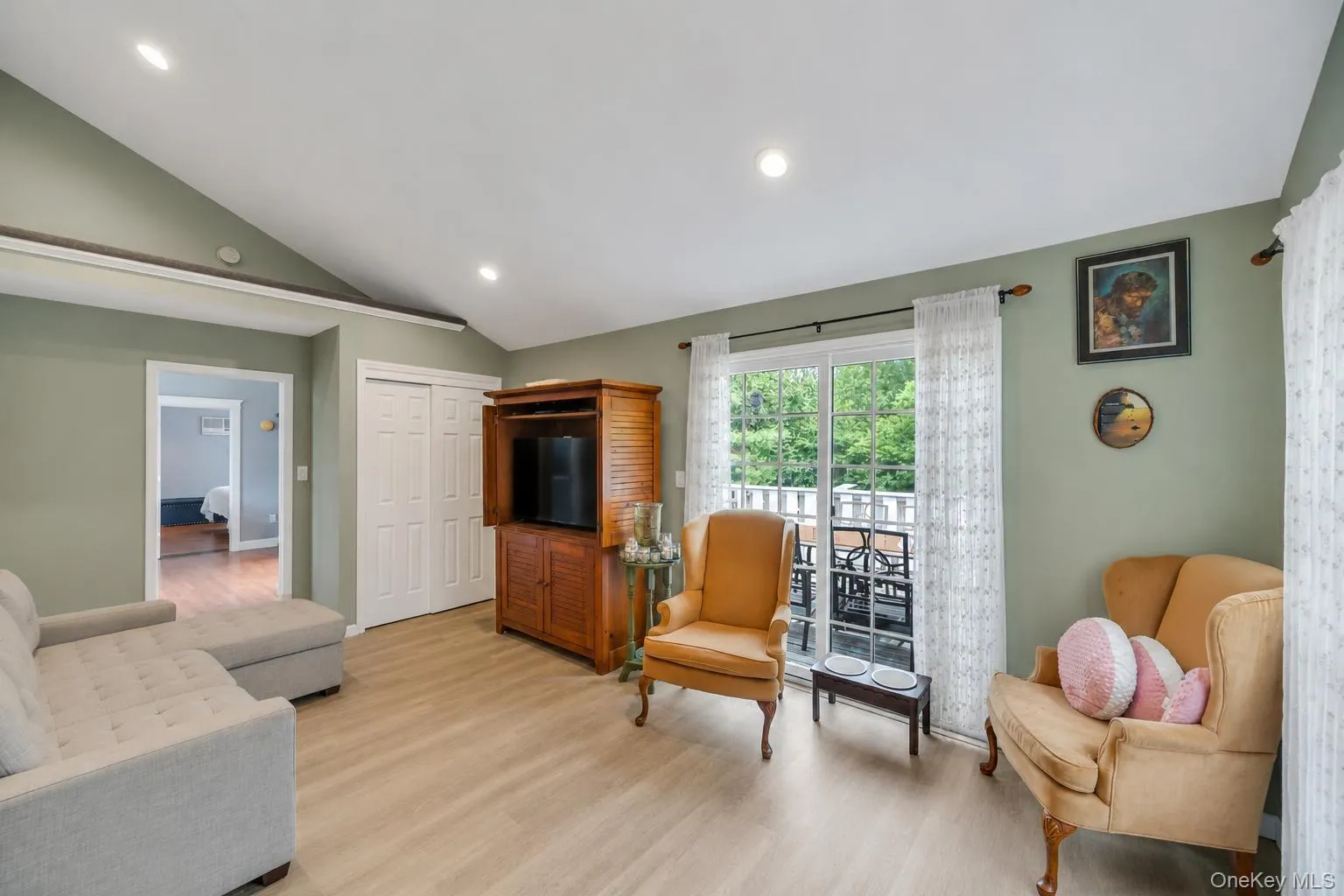 Vaulted ceilings with recessed lighting over wood-finish flooring Vaulted ceilings with recessed lighting over wood-finish flooring