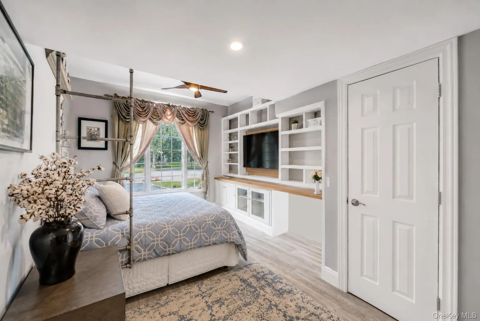 Built-in entertainment center with open shelving and wood-finish countertop Built-in entertainment center with open shelving and wood-finish countertop