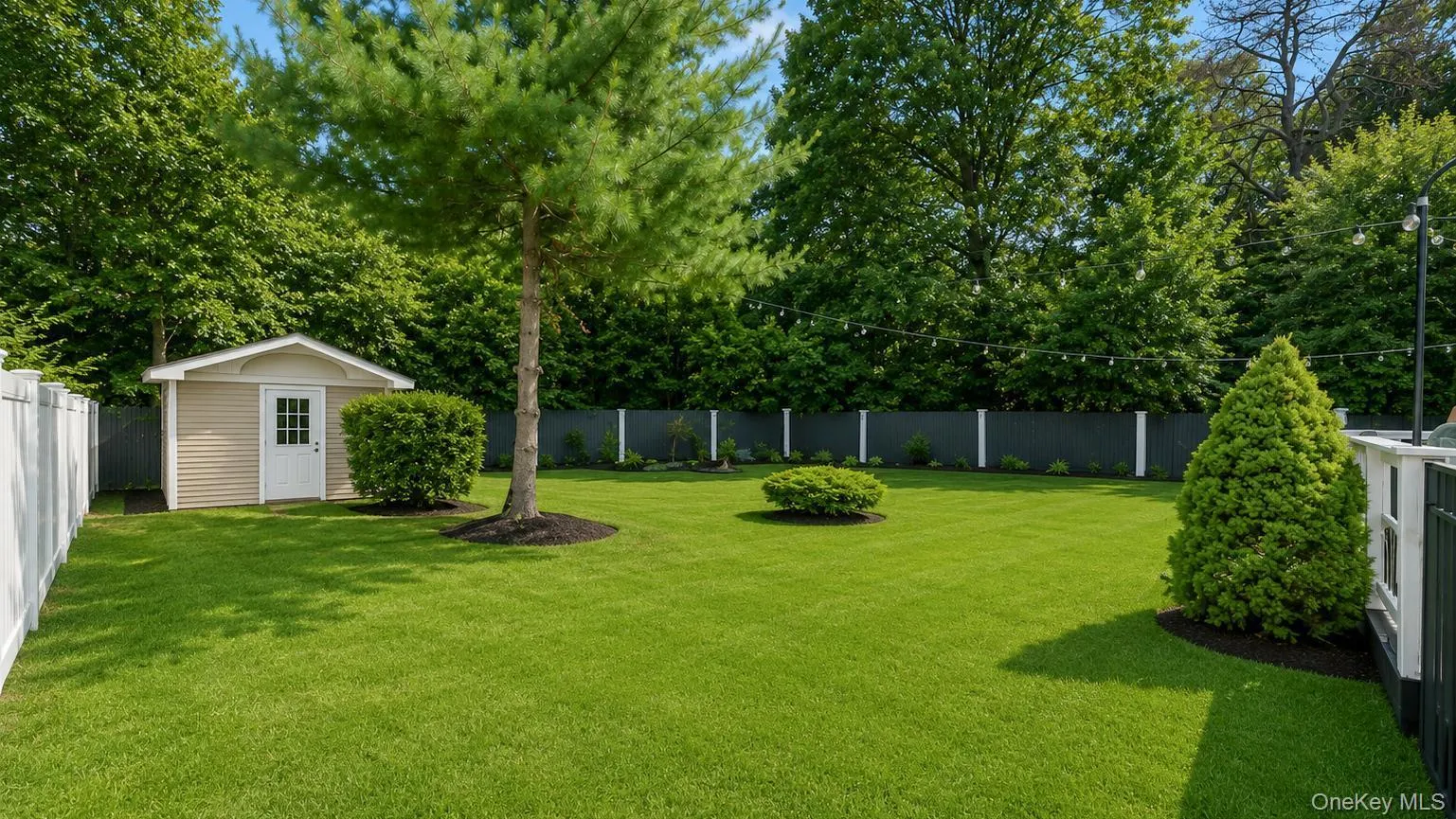 Expansive green lawn featuring a storage shed with siding, white trim, and a paneled door Expansive green lawn featuring a storage shed with siding, white trim, and a paneled door