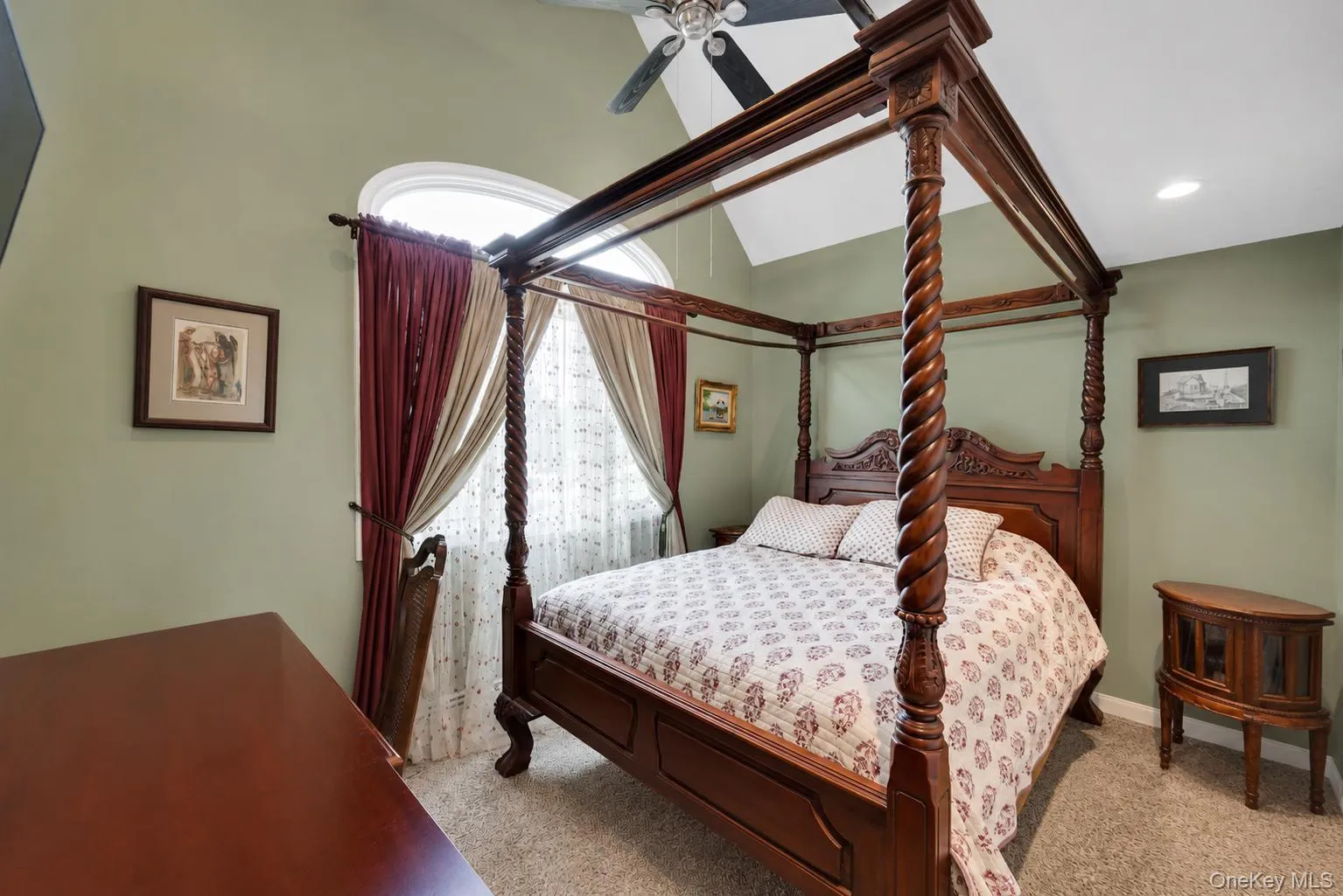 Vaulted ceiling with ceiling fan, arched window with decorative curtains, and recessed lighting Vaulted ceiling with ceiling fan, arched window with decorative curtains, and recessed lighting
