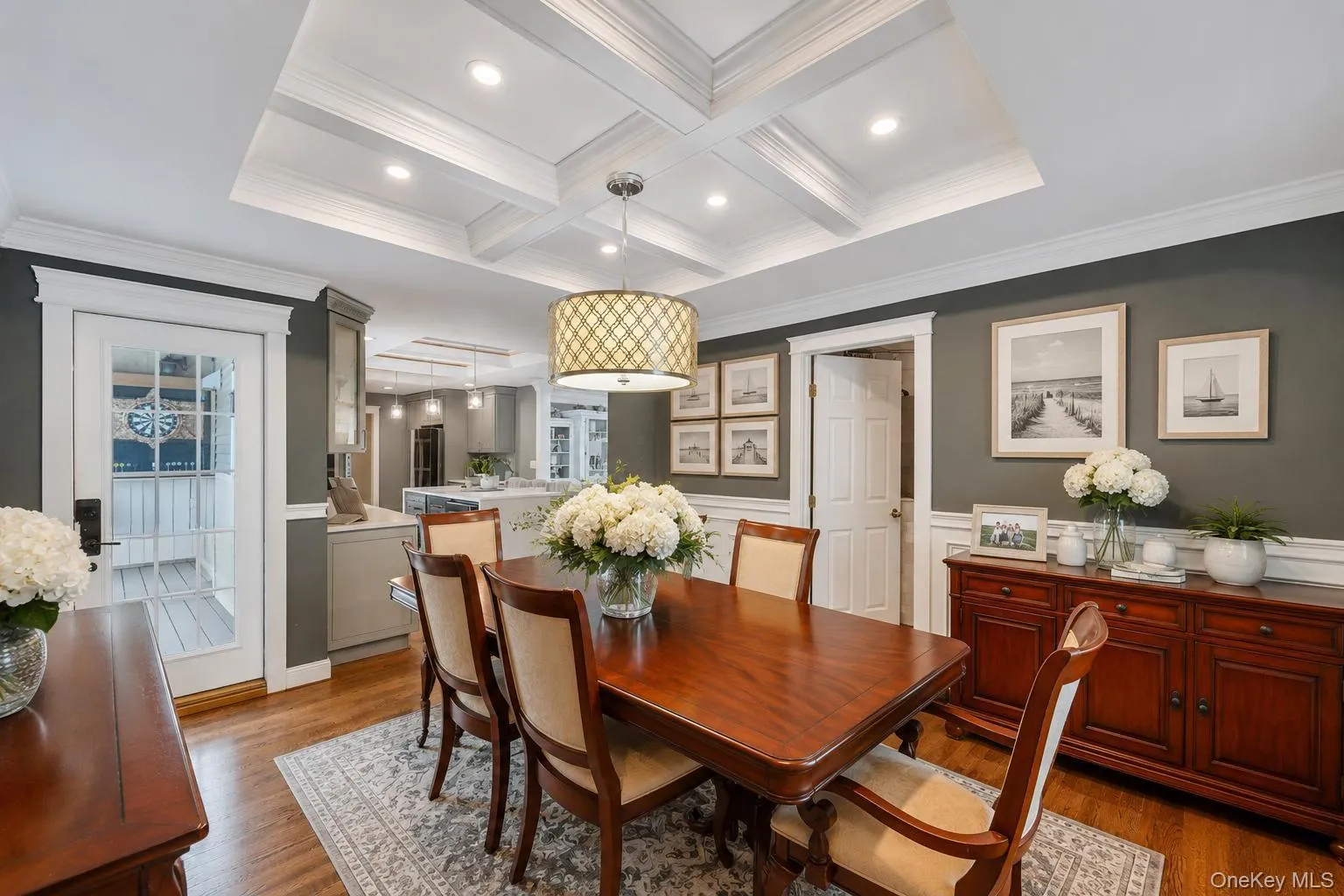 Dining area featuring a coffered ceiling, recessed lighting, and wood-finish flooring Dining area featuring a coffered ceiling, recessed lighting, and wood-finish flooring