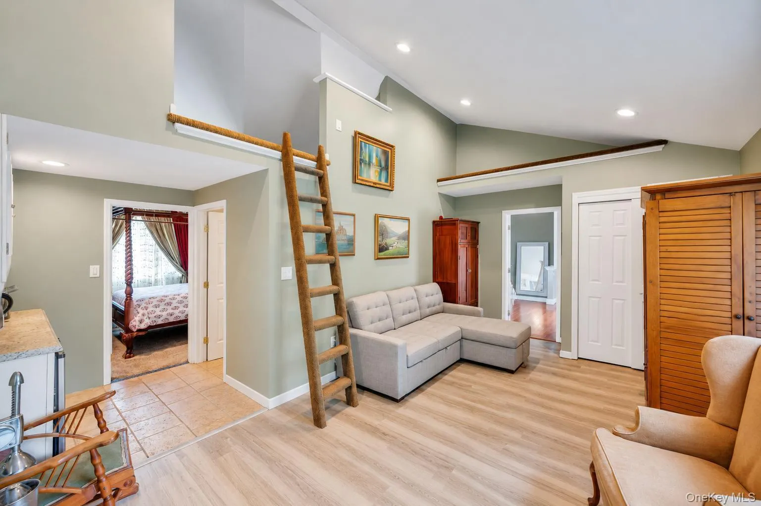 Vaulted ceilings with recessed lighting over wood-finish flooring Vaulted ceilings with recessed lighting over wood-finish flooring