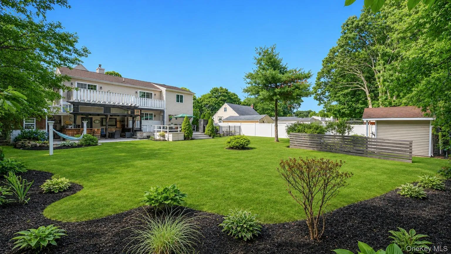 Expansive green lawn with mature perimeter trees Expansive green lawn with mature perimeter trees