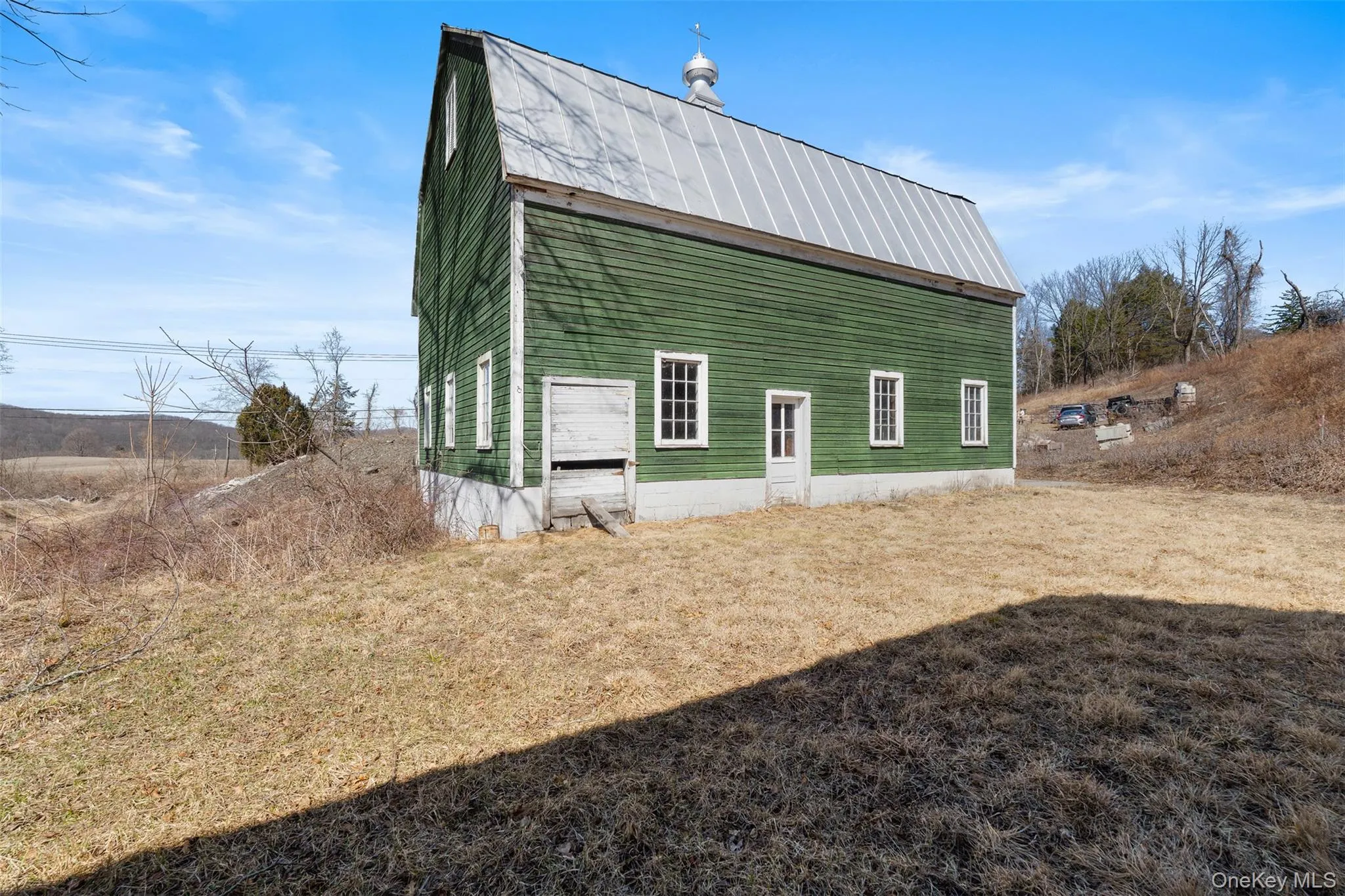View of property exterior with a metal roof View of property exterior with a metal roof