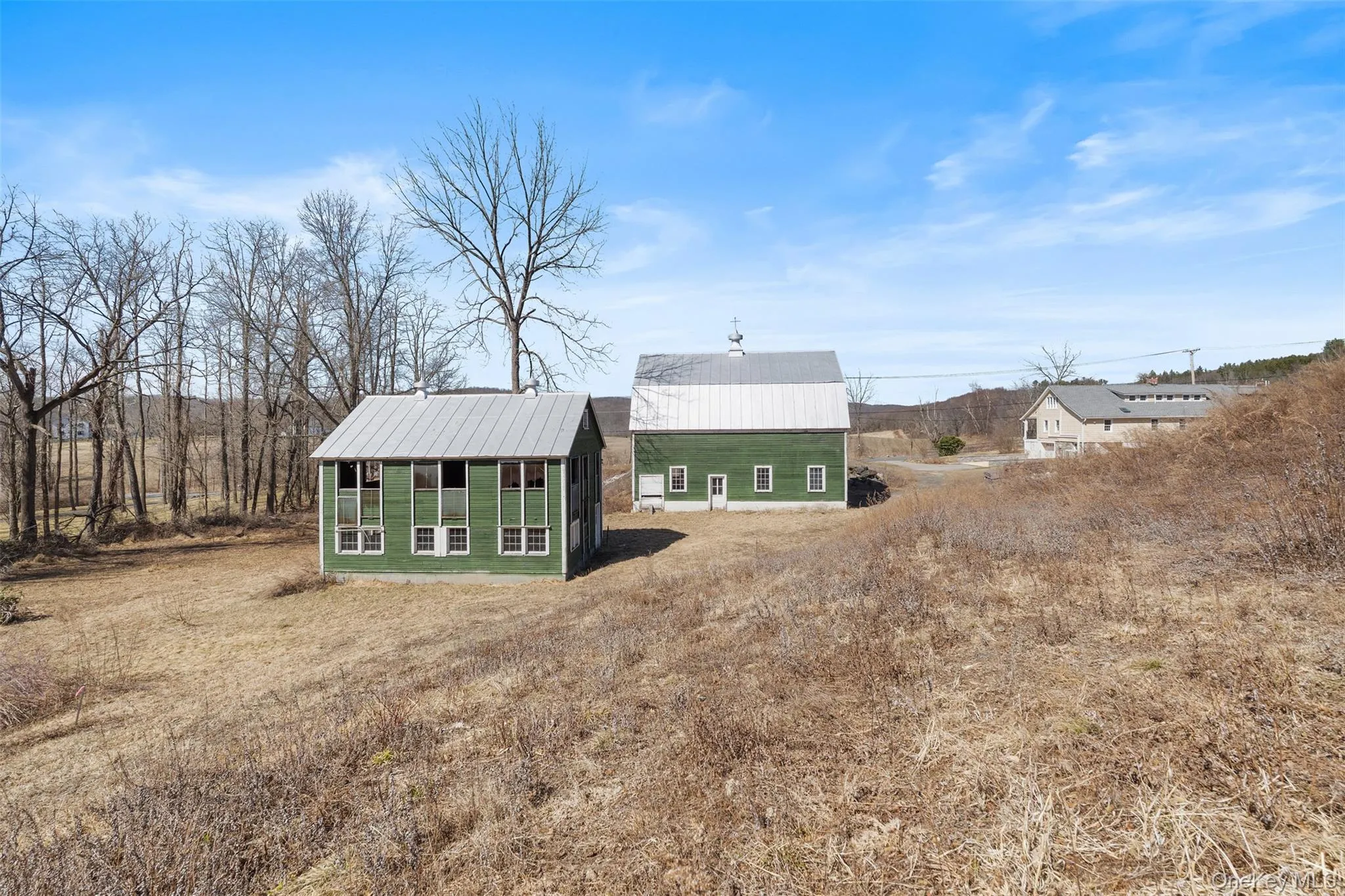 Back of property featuring an outbuilding and a metal roof Back of property featuring an outbuilding and a metal roof