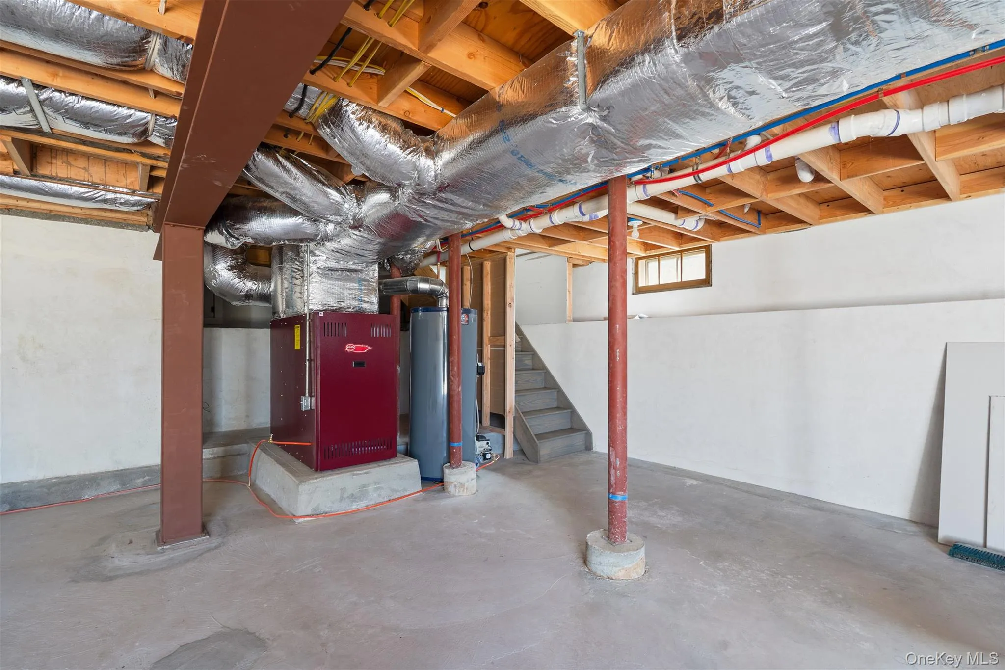 Basement with gas water heater, stairway, and heating unit Basement with gas water heater, stairway, and heating unit
