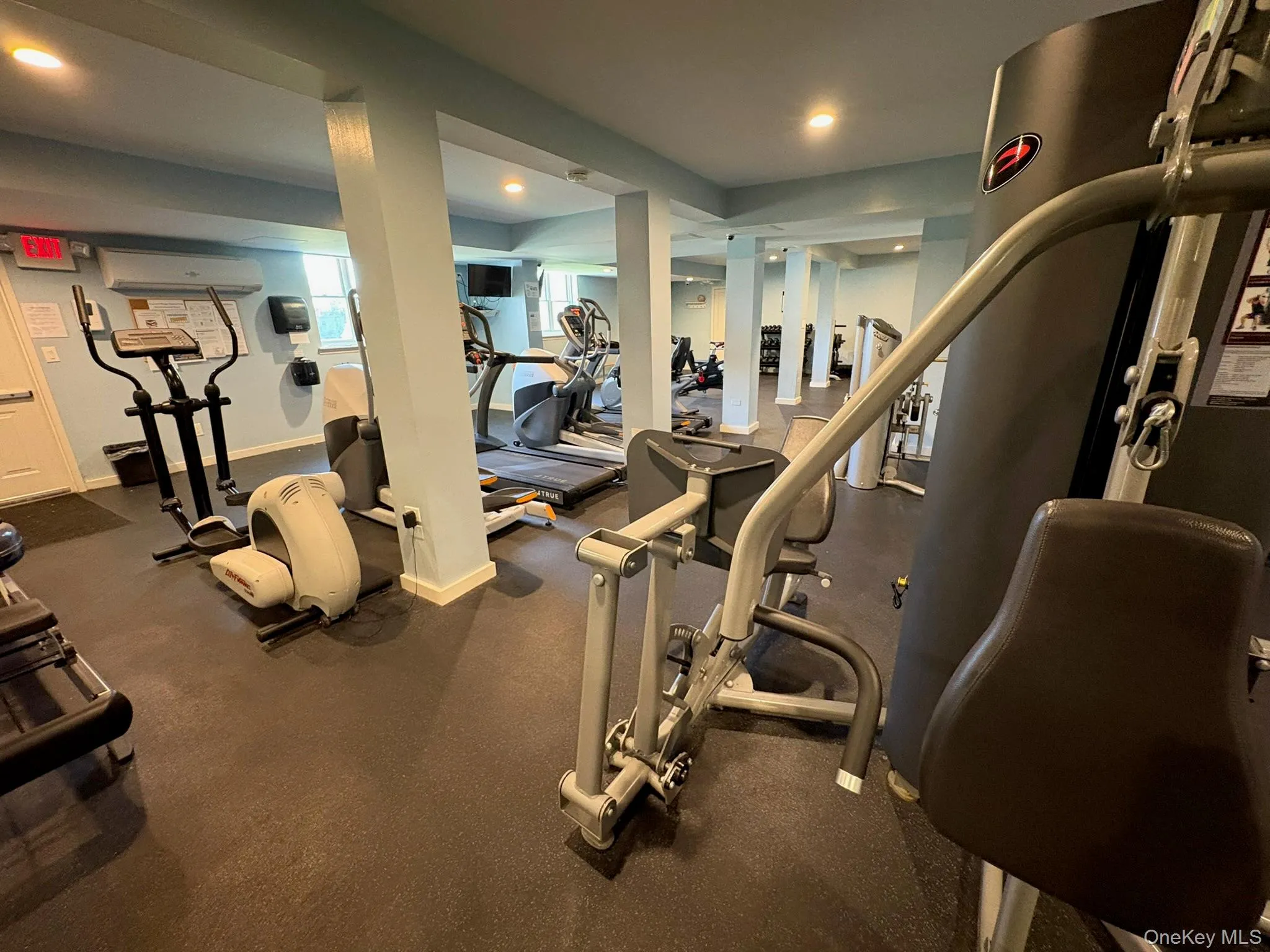Fitness center featuring commercial-grade gym equipment, recessed lighting, and durable rubber flooring Fitness center featuring commercial-grade gym equipment, recessed lighting, and durable rubber flooring