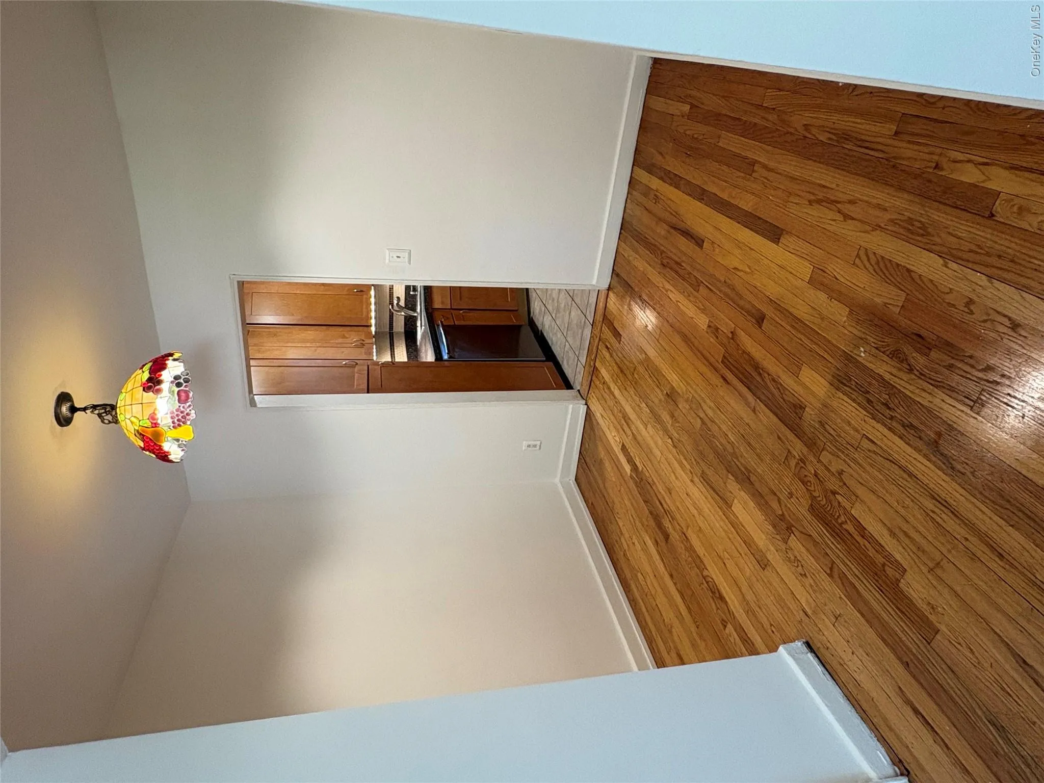 Hardwood flooring throughout a room with white painted walls and white baseboards Hardwood flooring throughout a room with white painted walls and white baseboards