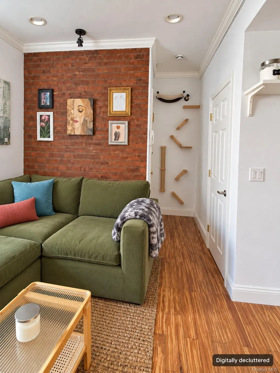 Exposed brick accent wall, wood-finish flooring, recessed lighting, crown molding, and white interior doors Exposed brick accent wall, wood-finish flooring, recessed lighting, crown molding, and white interior doors