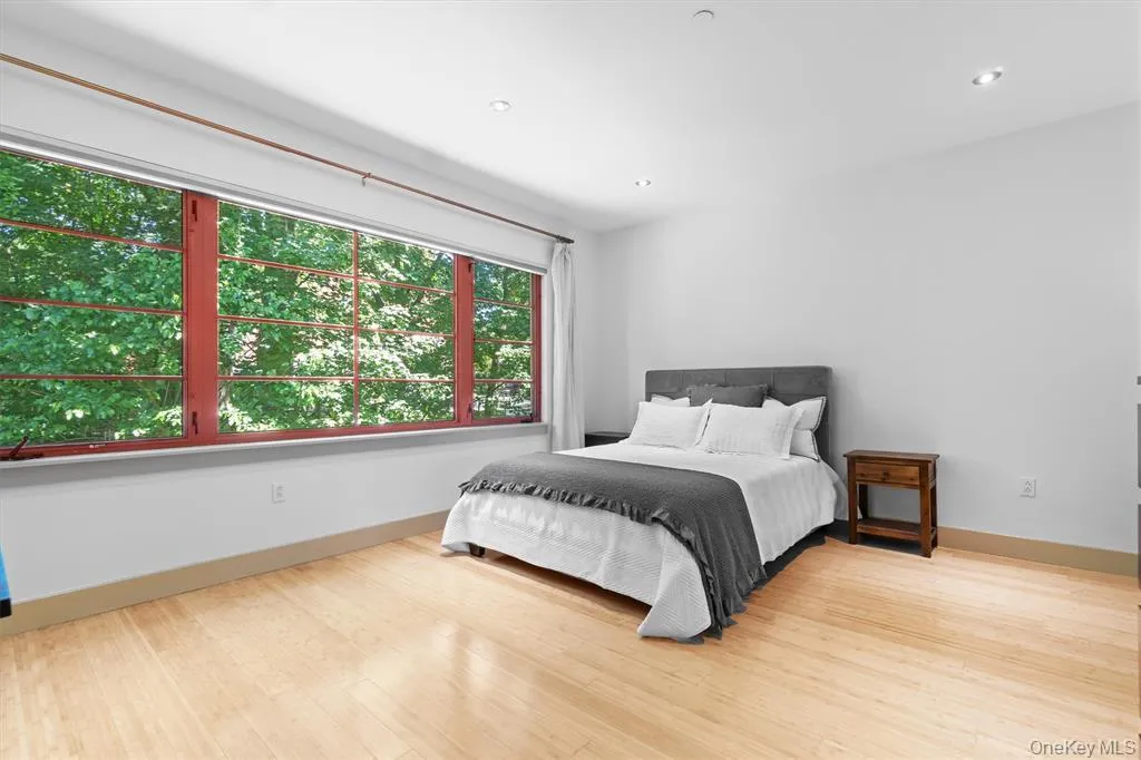 Bedroom featuring wood finished floors, baseboards, and recessed lighting Bedroom featuring wood finished floors, baseboards, and recessed lighting