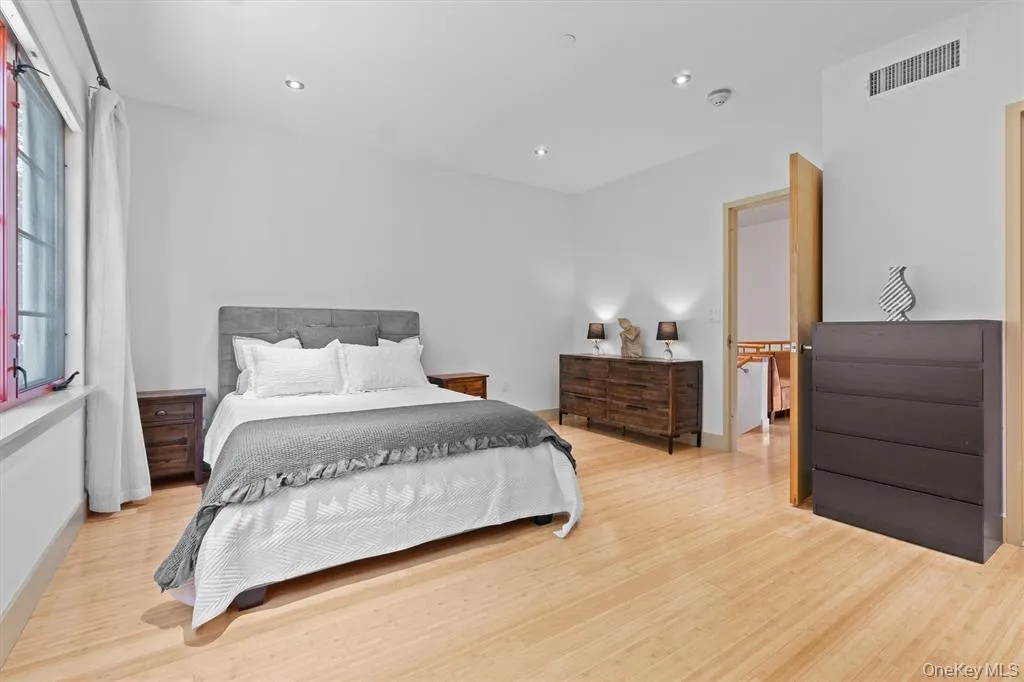 Bedroom featuring light wood-type flooring, recessed lighting, and baseboards Bedroom featuring light wood-type flooring, recessed lighting, and baseboards