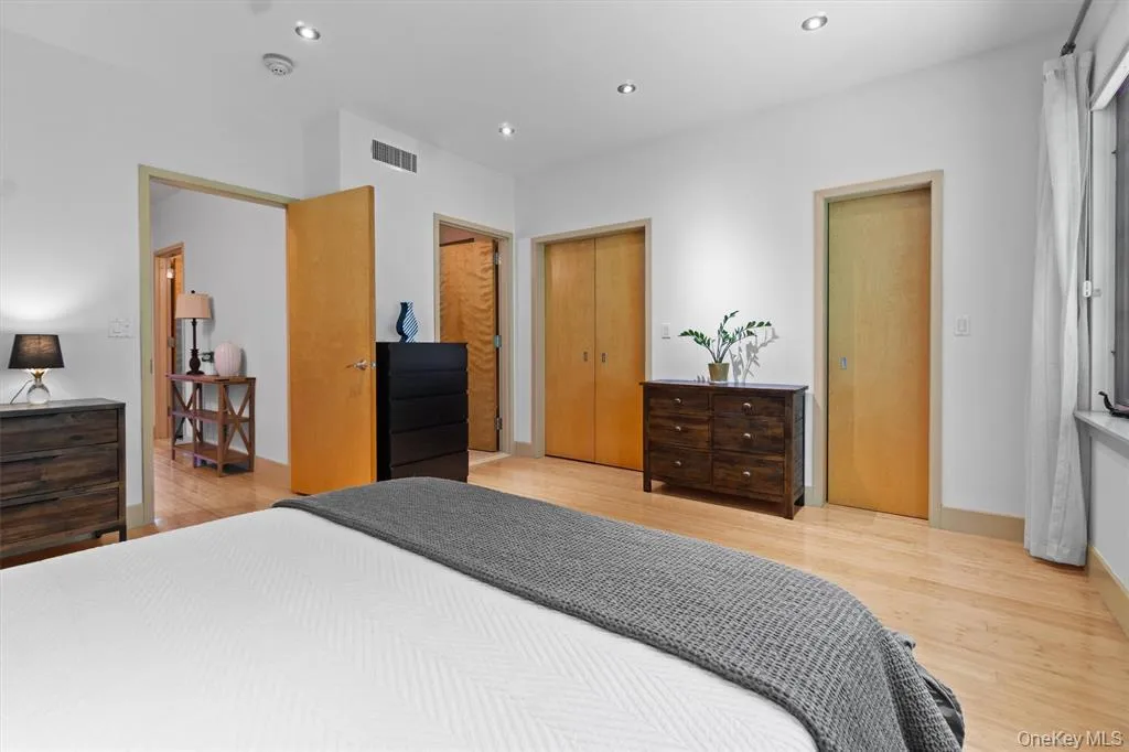 Bedroom with wood finished floors, recessed lighting, and baseboards Bedroom with wood finished floors, recessed lighting, and baseboards