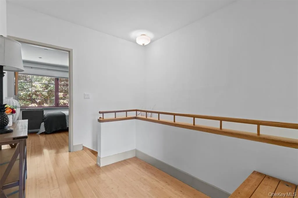 Hall with light wood-style flooring and baseboards Hall with light wood-style flooring and baseboards