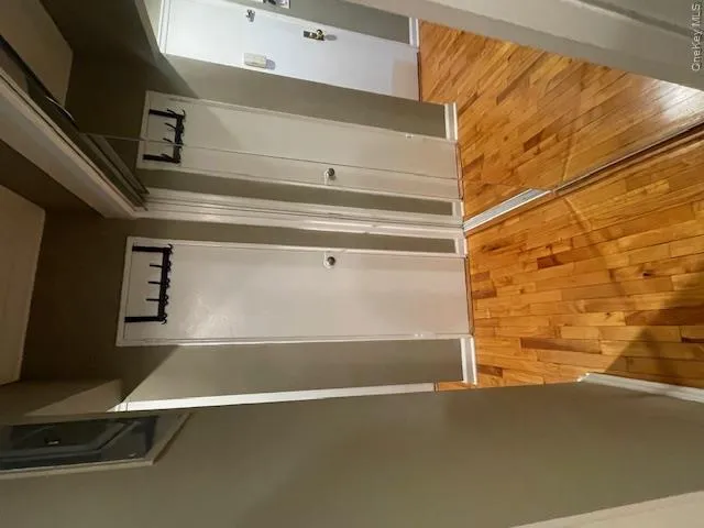 Hallway with light wood-style flooring Hallway with light wood-style flooring