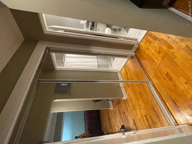Hall with light wood-style flooring and electric panel Hall with light wood-style flooring and electric panel