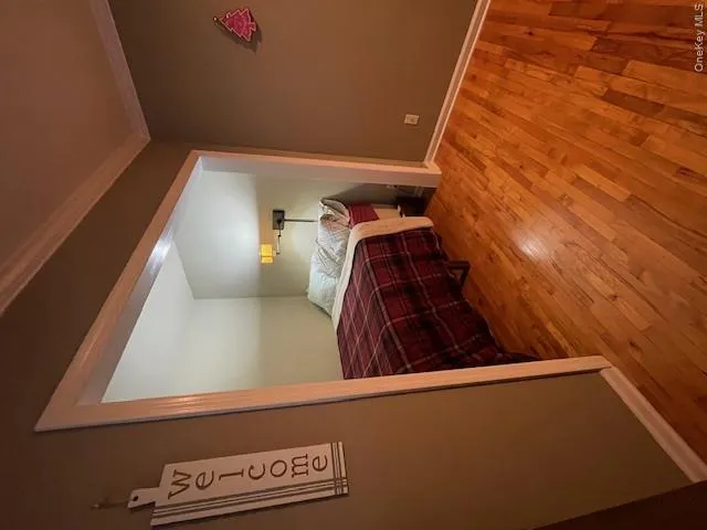 Bedroom with light wood-type flooring and crown molding Bedroom with light wood-type flooring and crown molding