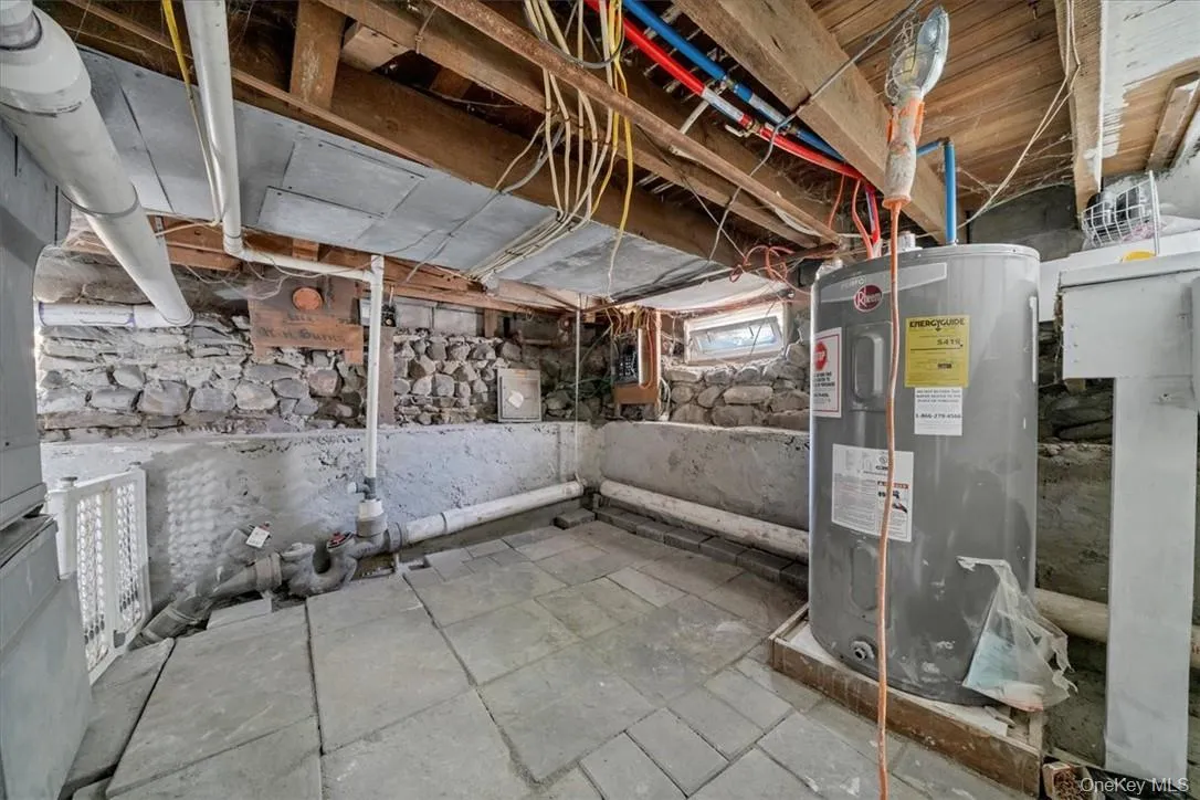 Basement featuring electric water heater Basement featuring electric water heater