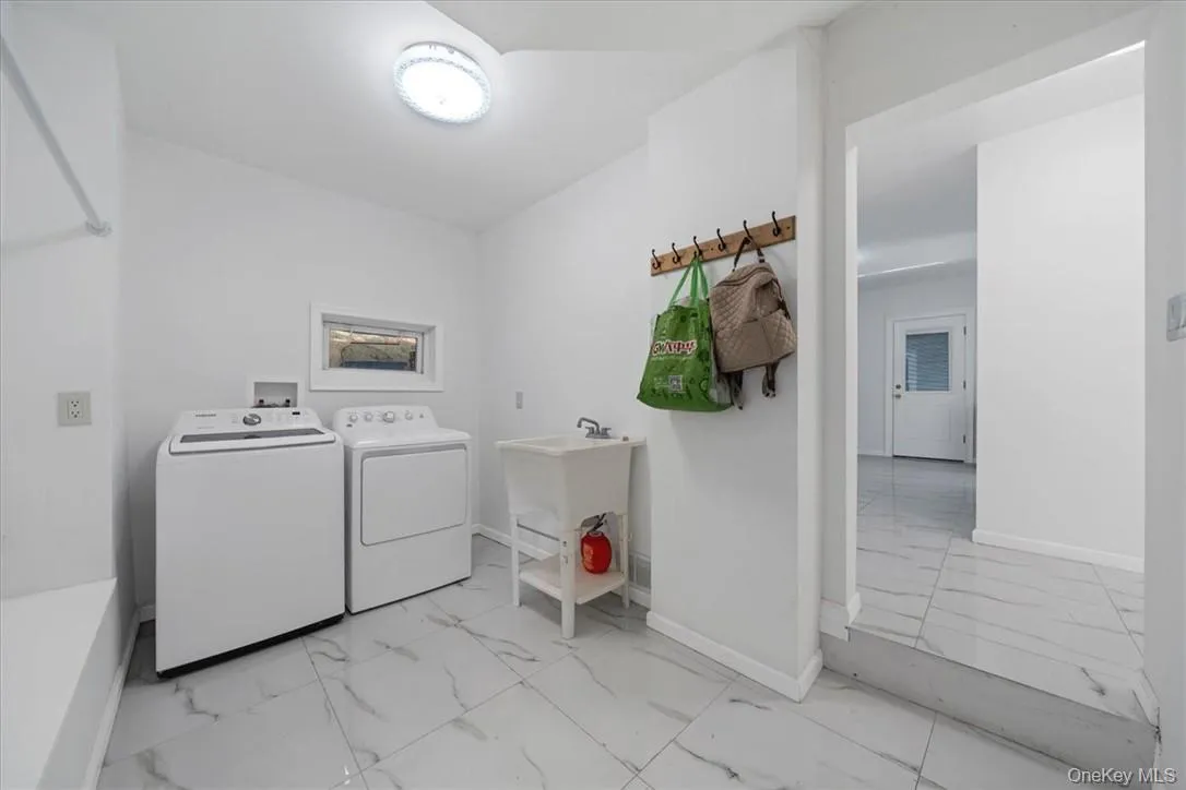 Clothes washing area with sink and washing machine and clothes dryer Clothes washing area with sink and washing machine and clothes dryer