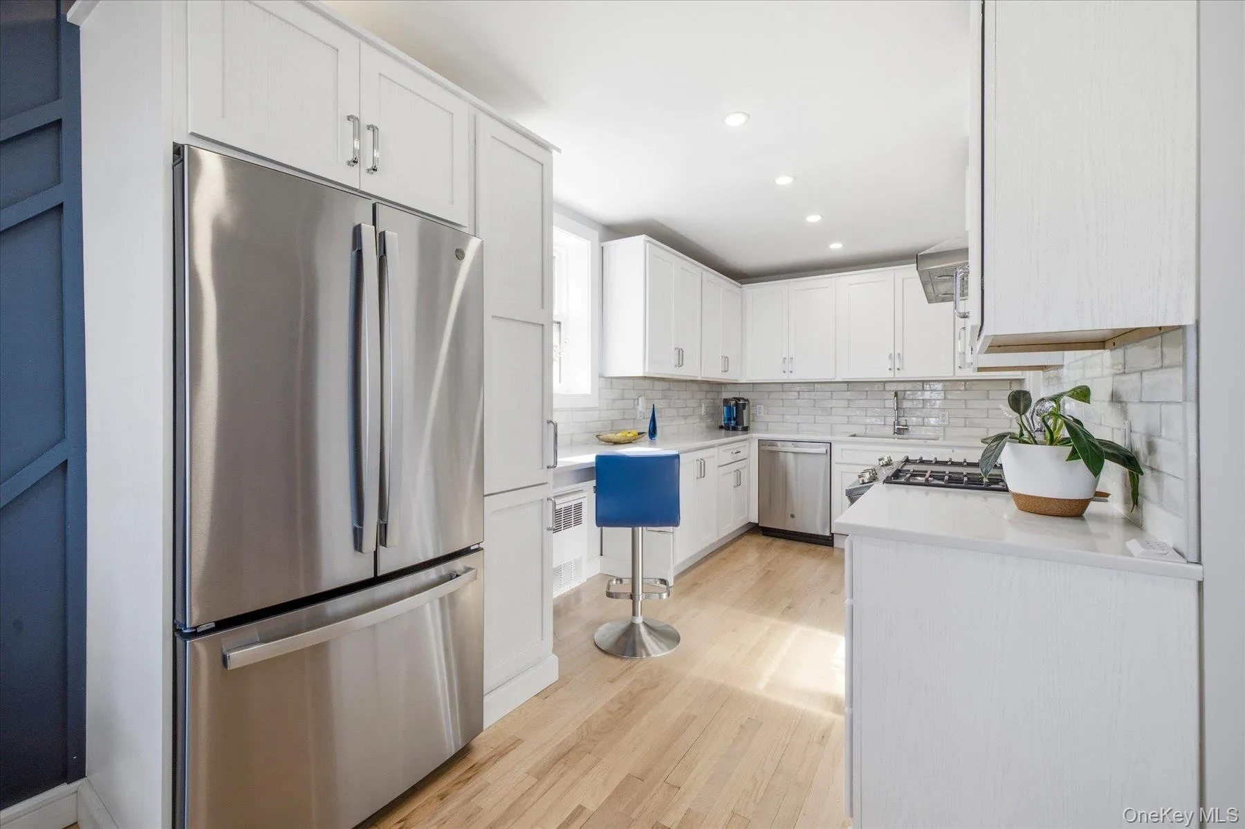 Brand new kitchen featuring white cabinetry, stainless steel appliances, and a subway tile backsplash Brand new kitchen featuring white cabinetry, stainless steel appliances, and a subway tile backsplash