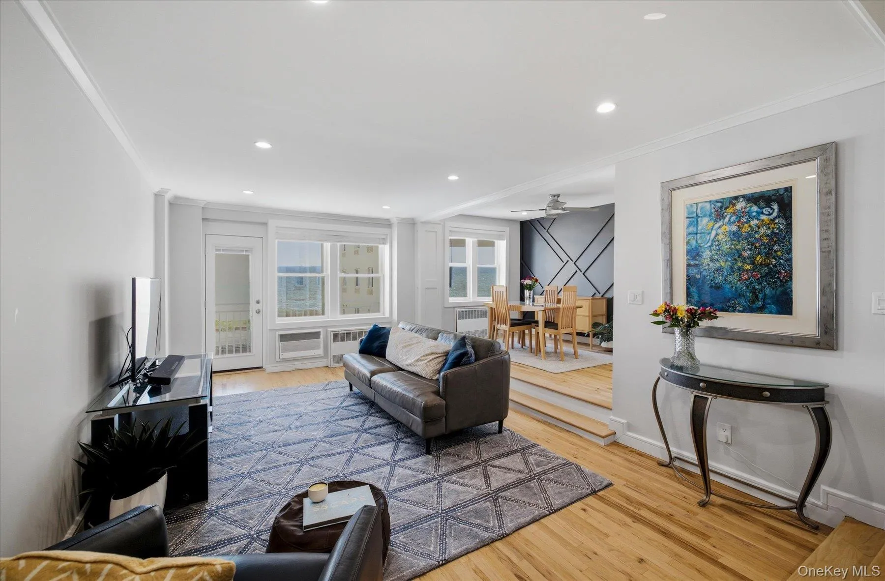 Living area with hardwood floors, recessed lighting, and ocean views Living area with hardwood floors, recessed lighting, and ocean views