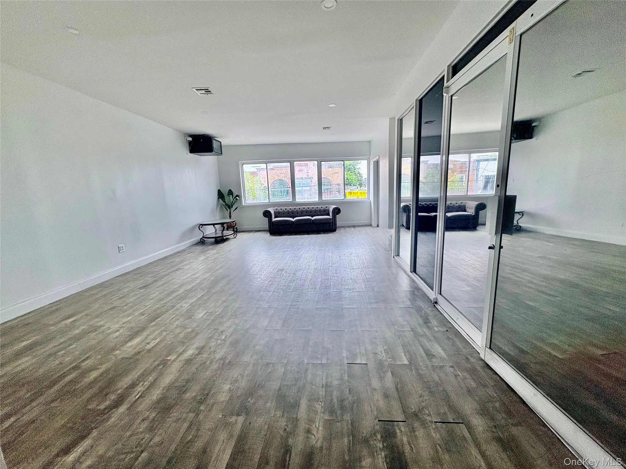 Spacious open-concept commercial area featuring abundant natural light, modern flooring, and a versatile layout ideal for a variety of business uses. Spacious open-concept commercial area featuring abundant natural light, modern flooring, and a versatile layout ideal for a variety of business uses.