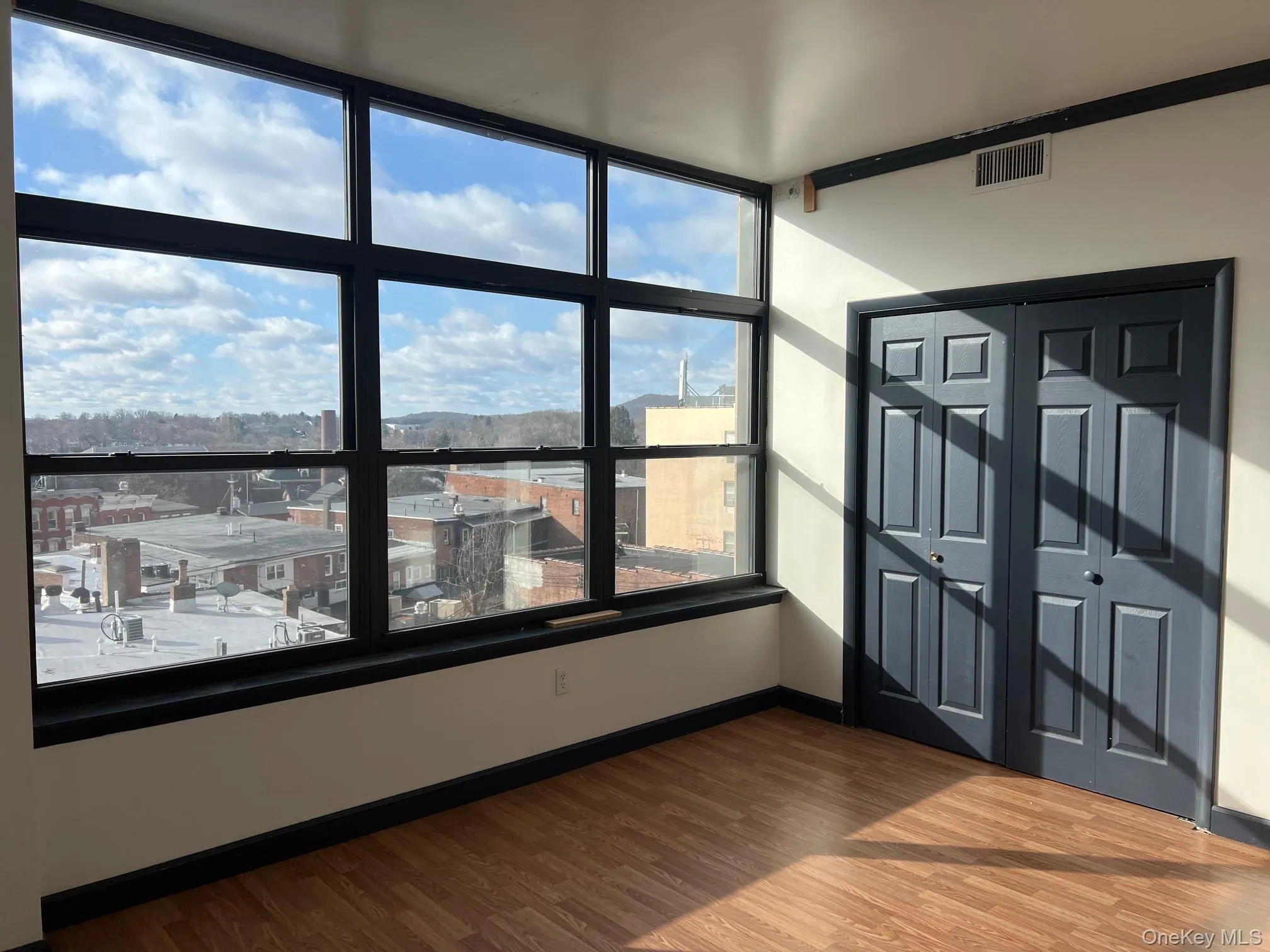 Empty room featuring hardwood / wood-style flooring Empty room featuring hardwood / wood-style flooring