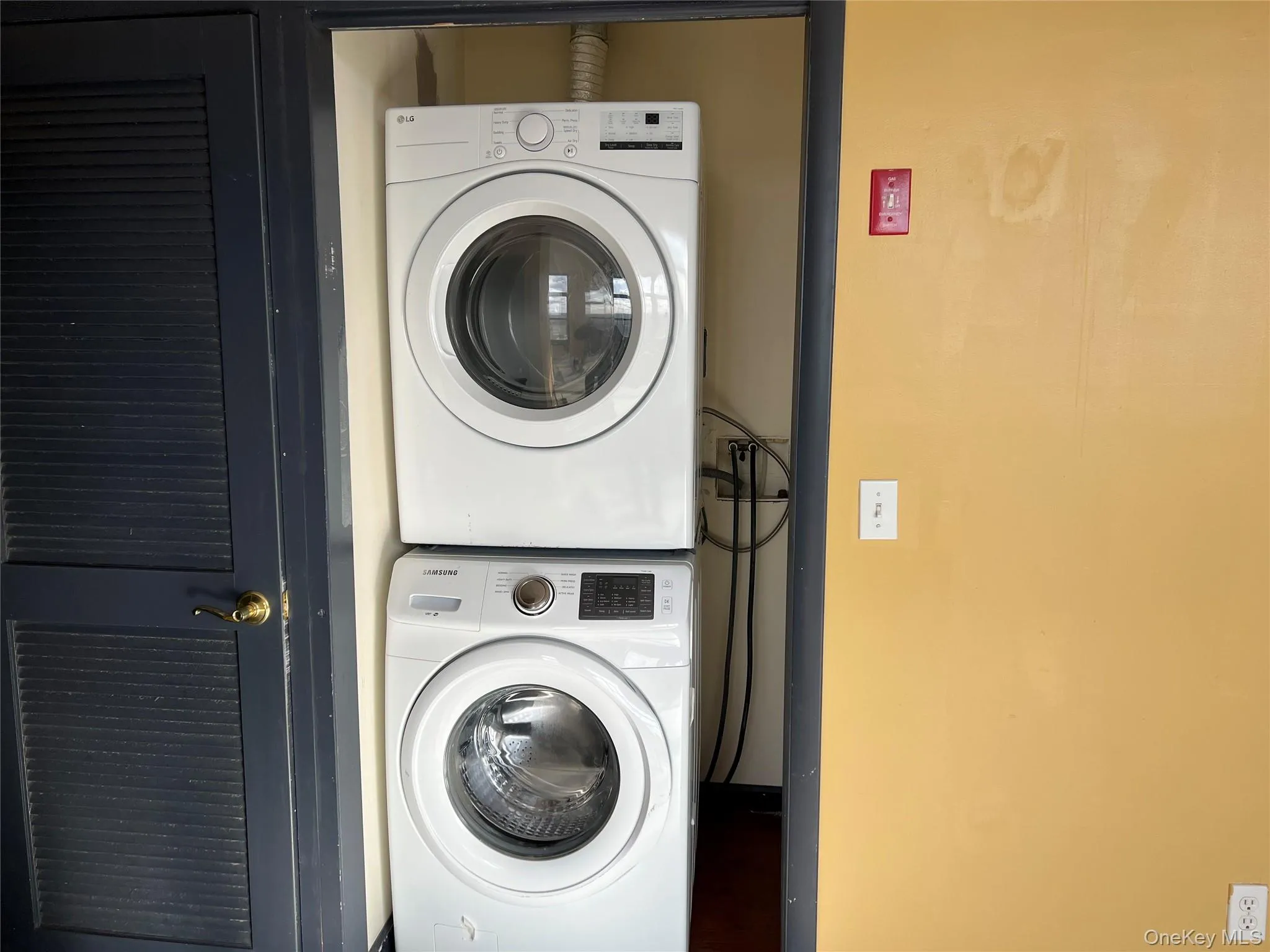 Washroom with stacked washer / dryer Washroom with stacked washer / dryer