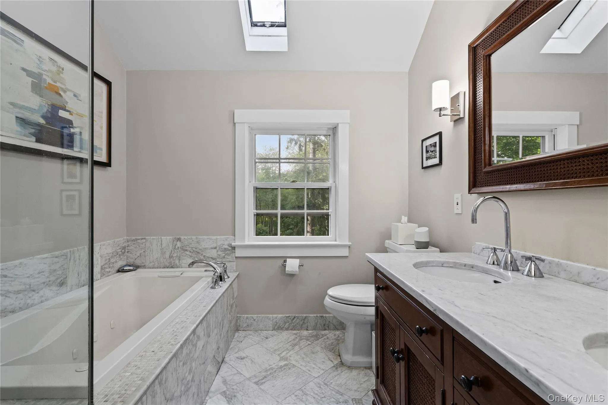 Primary Bathroom featuring a glass-enclosed shower with full tile surround, whirlpool tub with tile surround, and a dual vanity with undermount sinks and stone countertops. Primary Bathroom featuring a glass-enclosed shower with full tile surround, whirlpool tub with tile surround, and a dual vanity with undermount sinks and stone countertops.