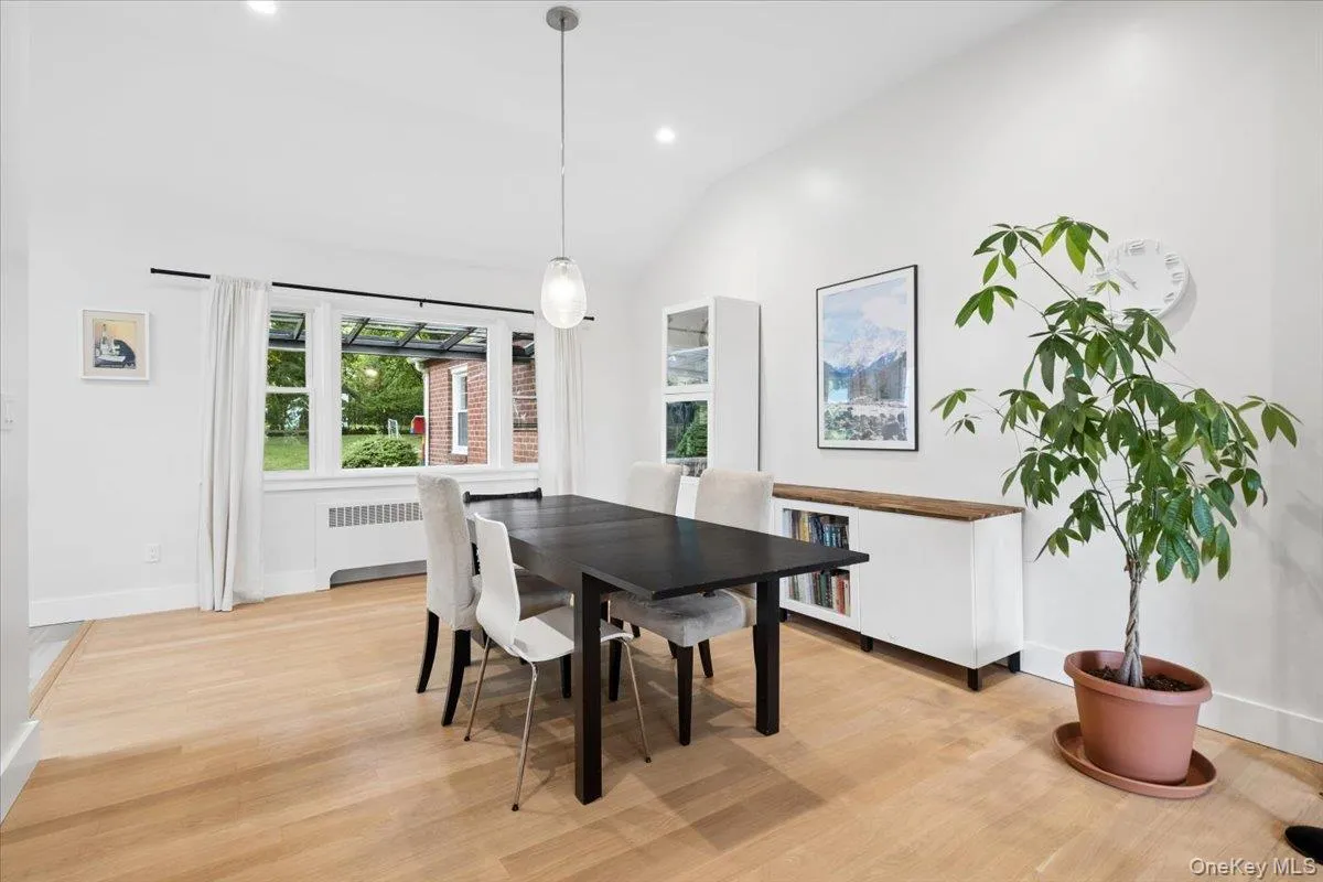 Bright interior space featuring hard wood-flooring and a high vaulted ceiling Bright interior space featuring hard wood-flooring and a high vaulted ceiling