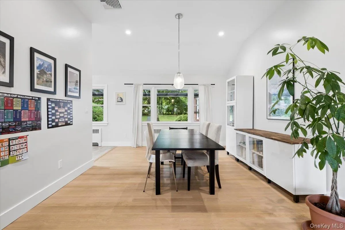 Spacious dining area , with a vaulted ceiling and a contemporary pendant light fixture Spacious dining area , with a vaulted ceiling and a contemporary pendant light fixture