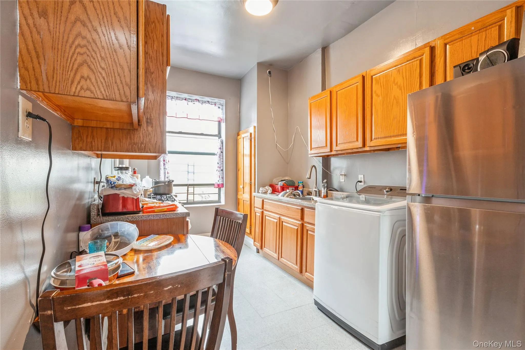 Kitchen with sink, washer / dryer, and stainless steel refrigerator Kitchen with sink, washer / dryer, and stainless steel refrigerator