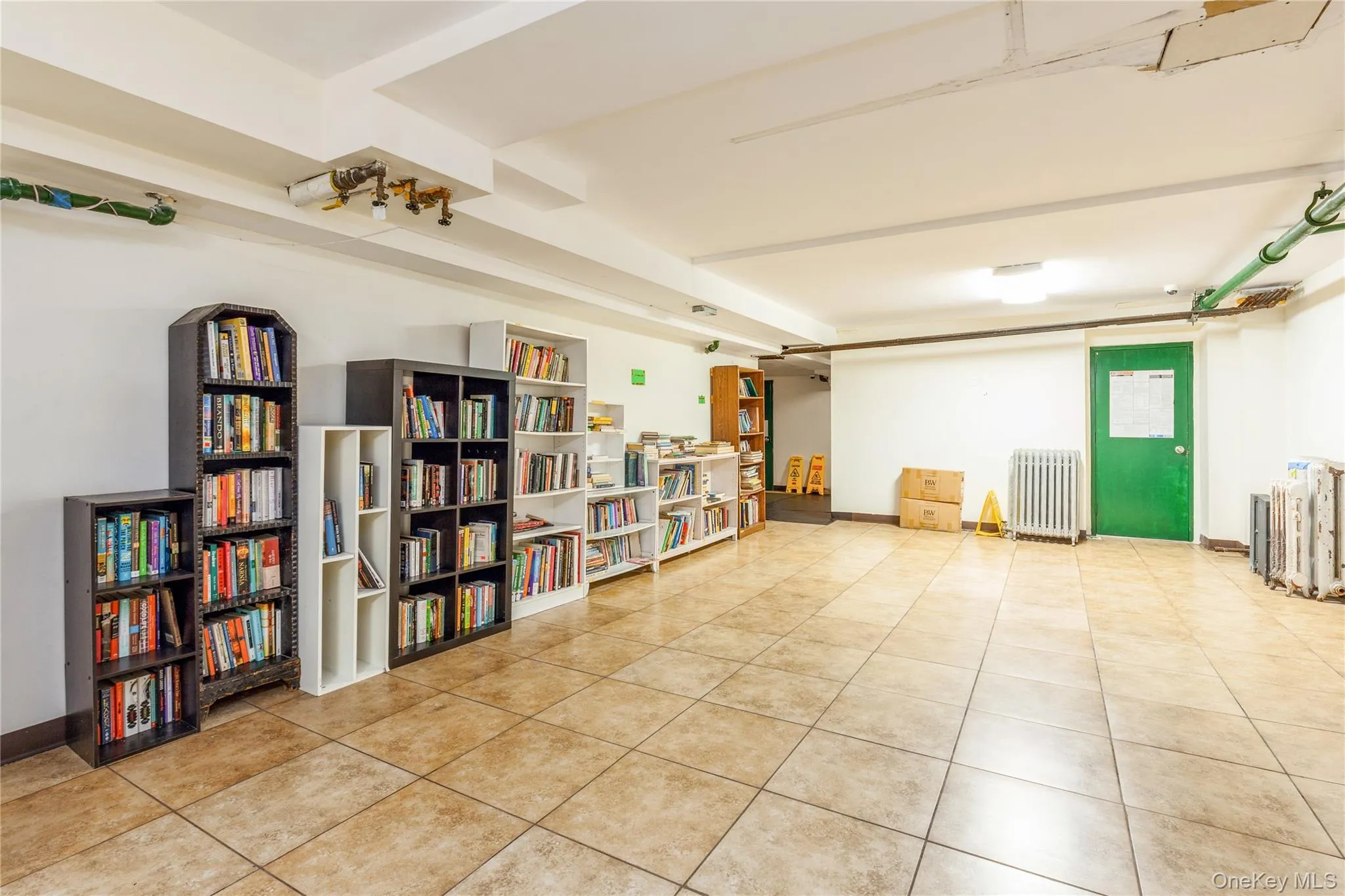 Miscellaneous community room with radiator and light tile patterned floors Miscellaneous community room with radiator and light tile patterned floors