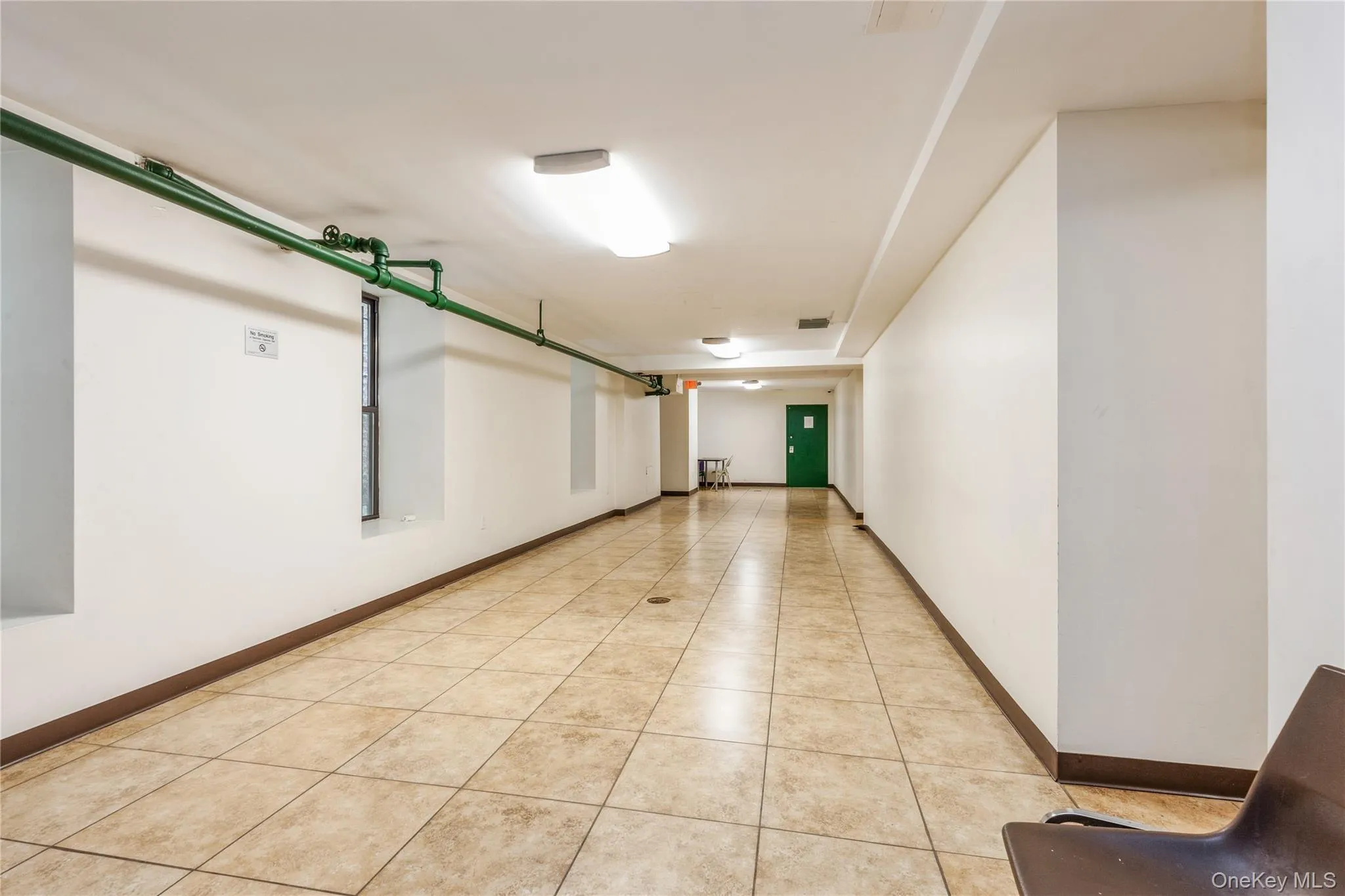 Hallway featuring light tile patterned floors Hallway featuring light tile patterned floors