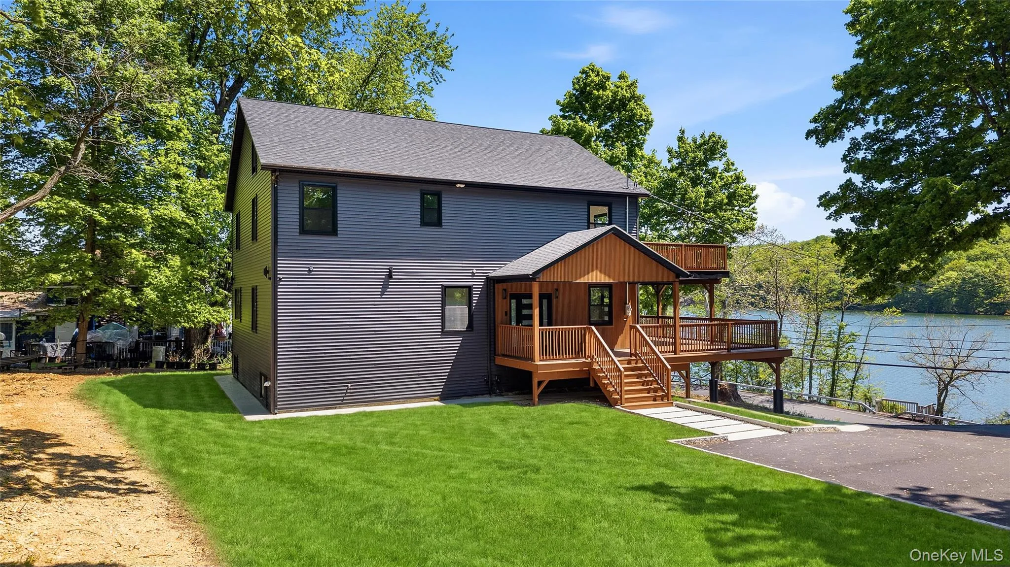 Contemporary siding exterior with a multi-level wood deck and covered porch Contemporary siding exterior with a multi-level wood deck and covered porch