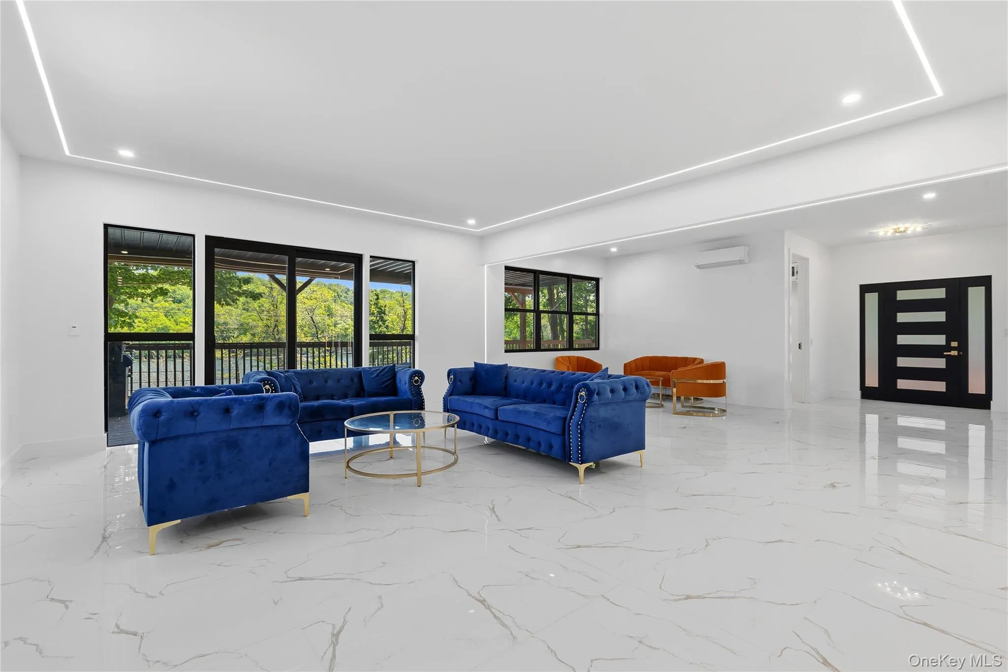 Spacious interior with large format white and gray veined tile flooring Spacious interior with large format white and gray veined tile flooring