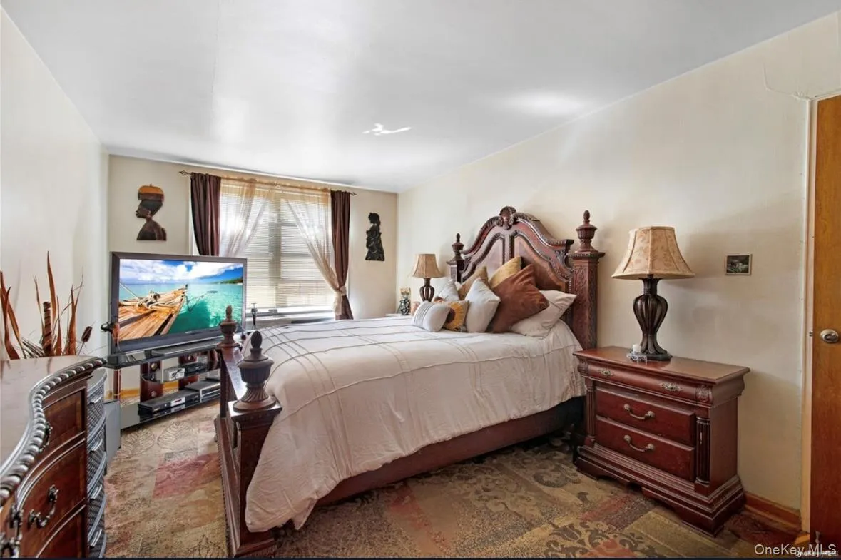 Bedroom with light-colored walls and a window featuring sheer and opaque drapes Bedroom with light-colored walls and a window featuring sheer and opaque drapes