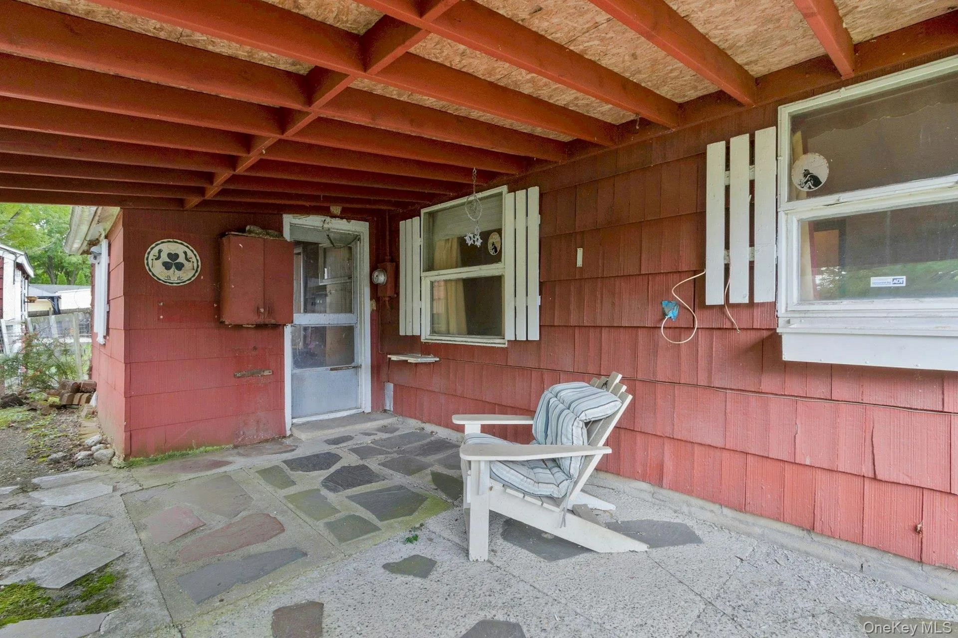 Covered patio with entry to Enclosed Utility Room. Covered patio with entry to Enclosed Utility Room.