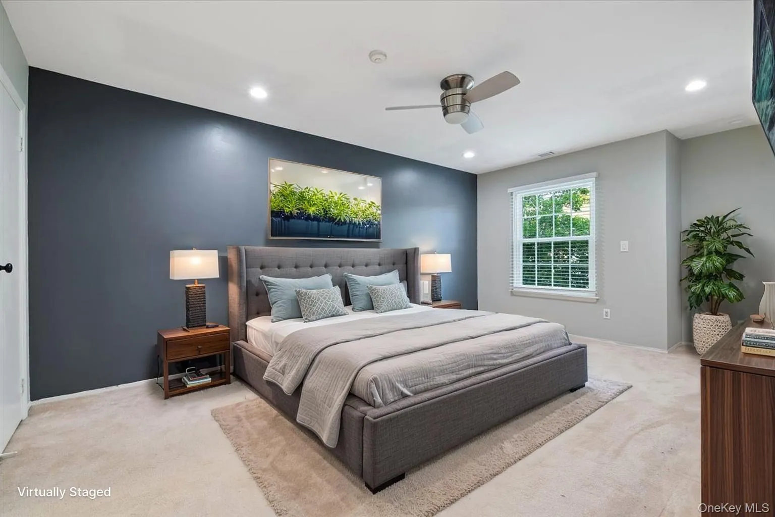 Carpeted bedroom featuring a dark accent wall, recessed lighting, and a ceiling fan Carpeted bedroom featuring a dark accent wall, recessed lighting, and a ceiling fan