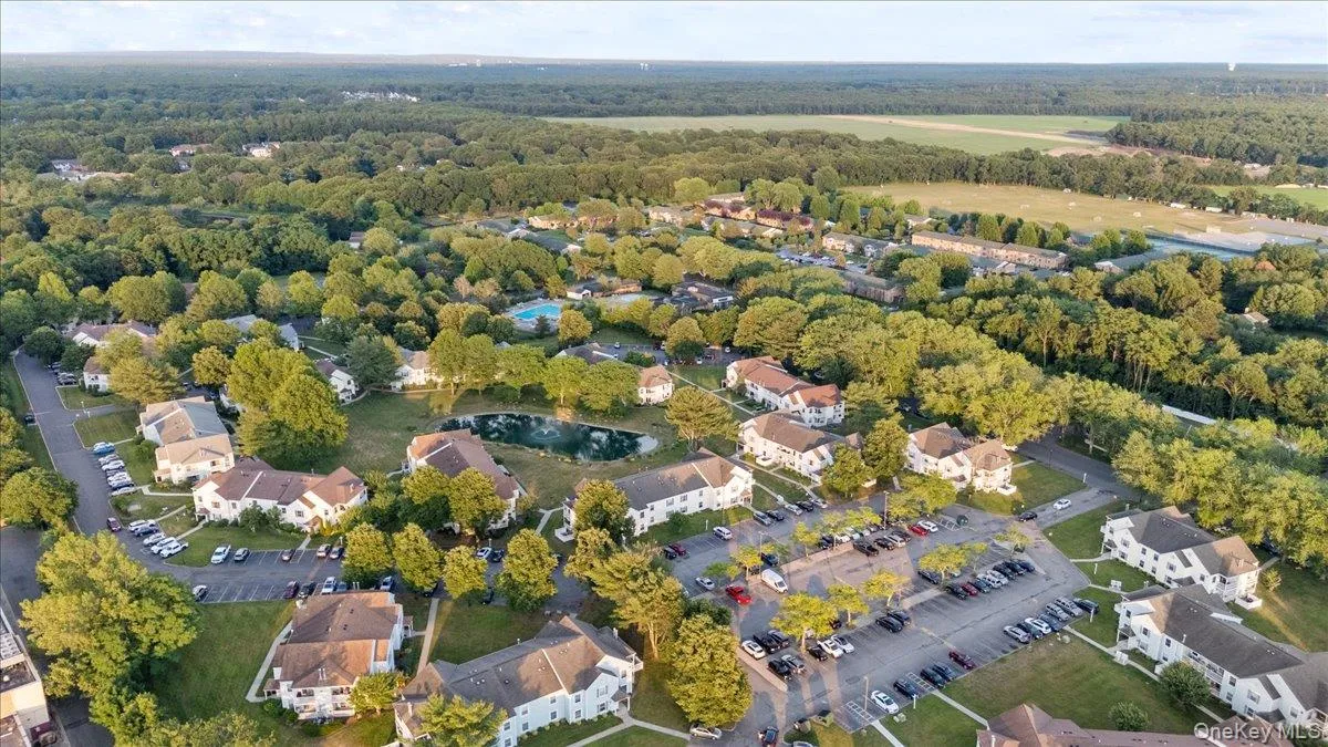 Aerial perspective showcasing a residential community amidst extensive green space Aerial perspective showcasing a residential community amidst extensive green space