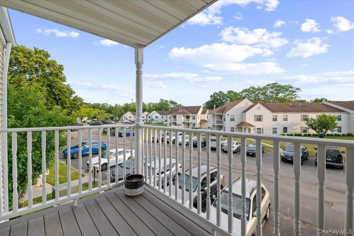 Private balcony featuring composite decking, white railing, and a matching support column Private balcony featuring composite decking, white railing, and a matching support column