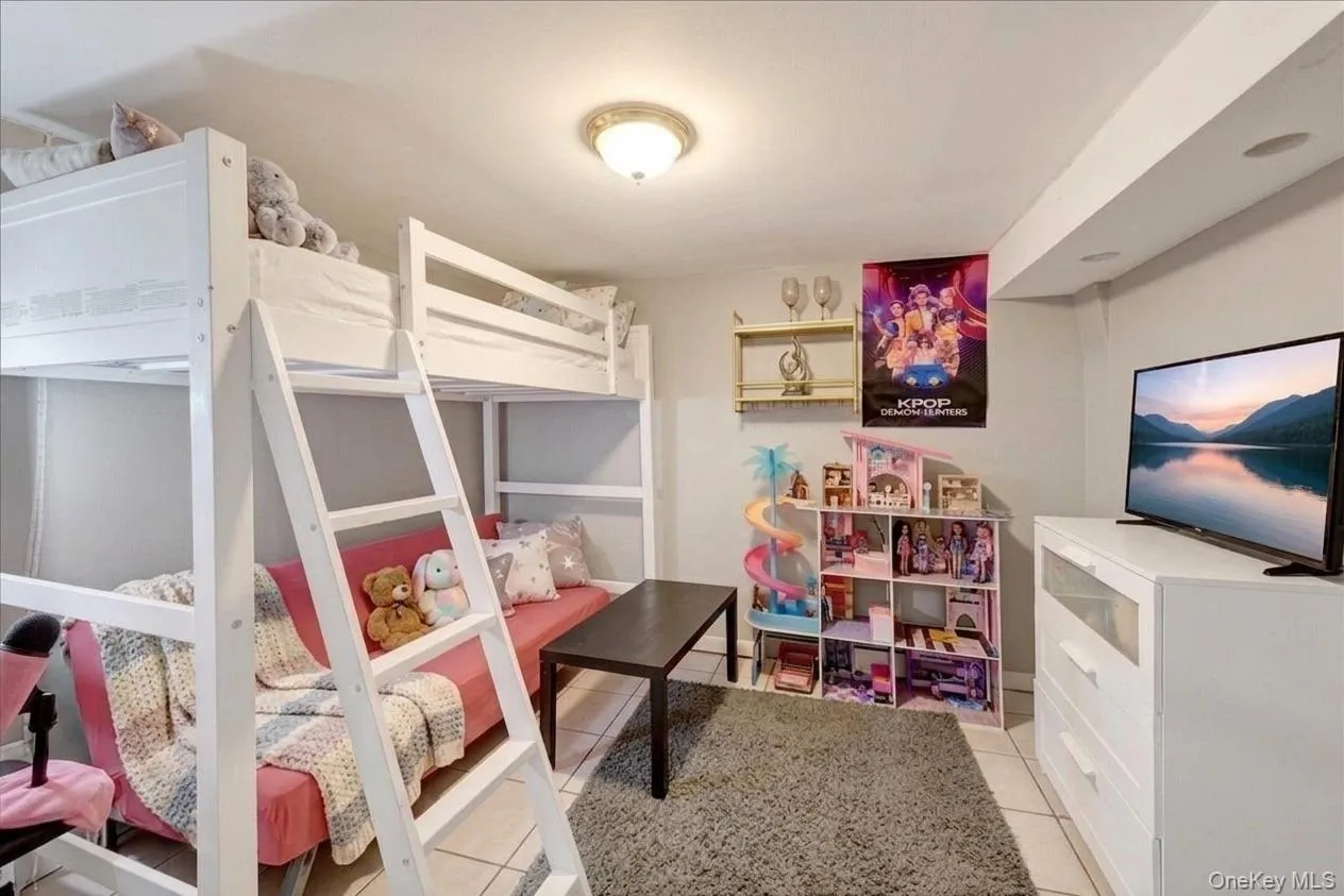 Basement Bonus Room. White bunk beds with ladder, neutral wall tones, recessed lighting, and a flush mount ceiling fixture Basement Bonus Room. White bunk beds with ladder, neutral wall tones, recessed lighting, and a flush mount ceiling fixture