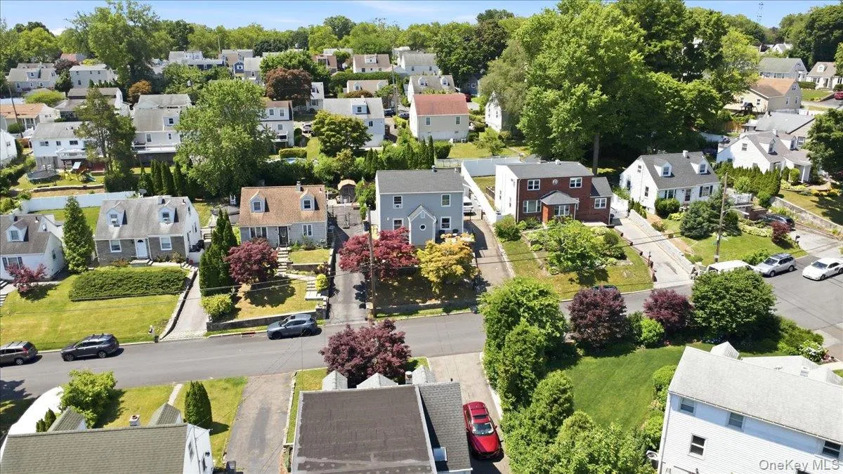 Residential street lined with various architectural style homes and mature trees Residential street lined with various architectural style homes and mature trees