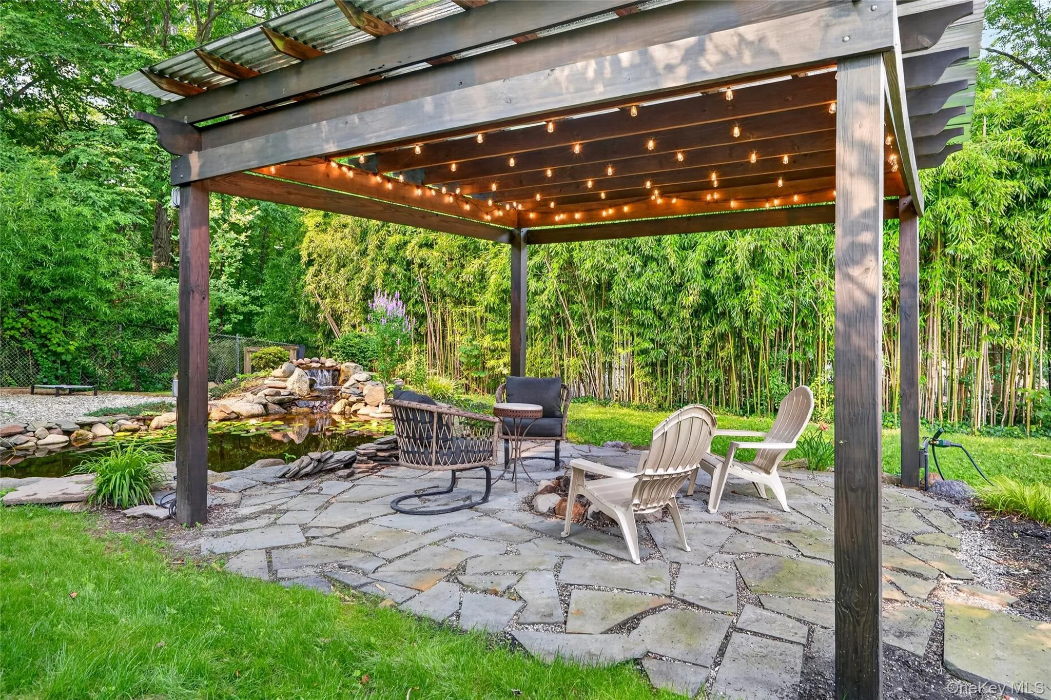 Relax under the pergola next to the tranquil koi pond Relax under the pergola next to the tranquil koi pond