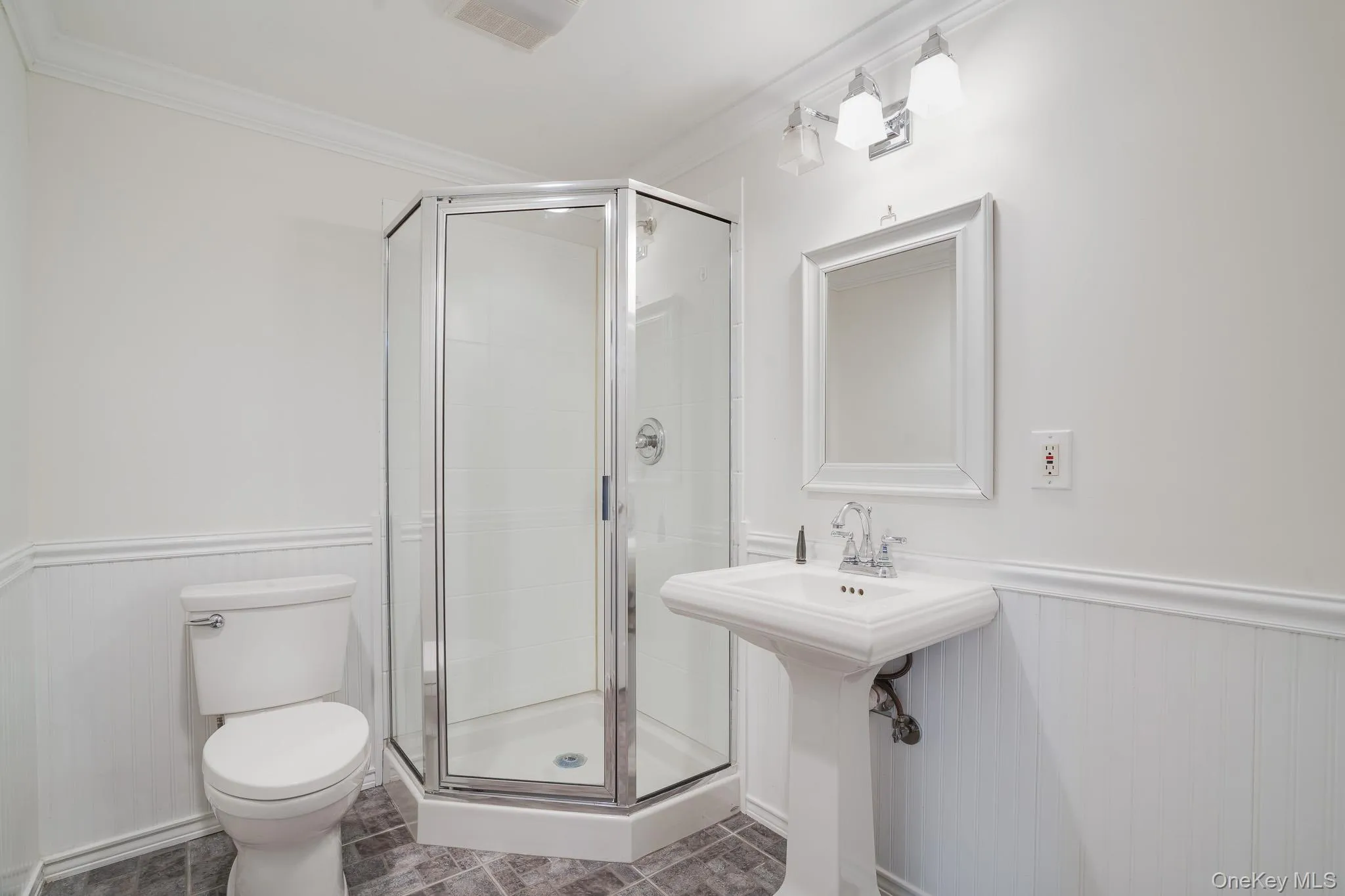 Basement bath featuring pedestal sink and corner stand-up shower Basement bath featuring pedestal sink and corner stand-up shower