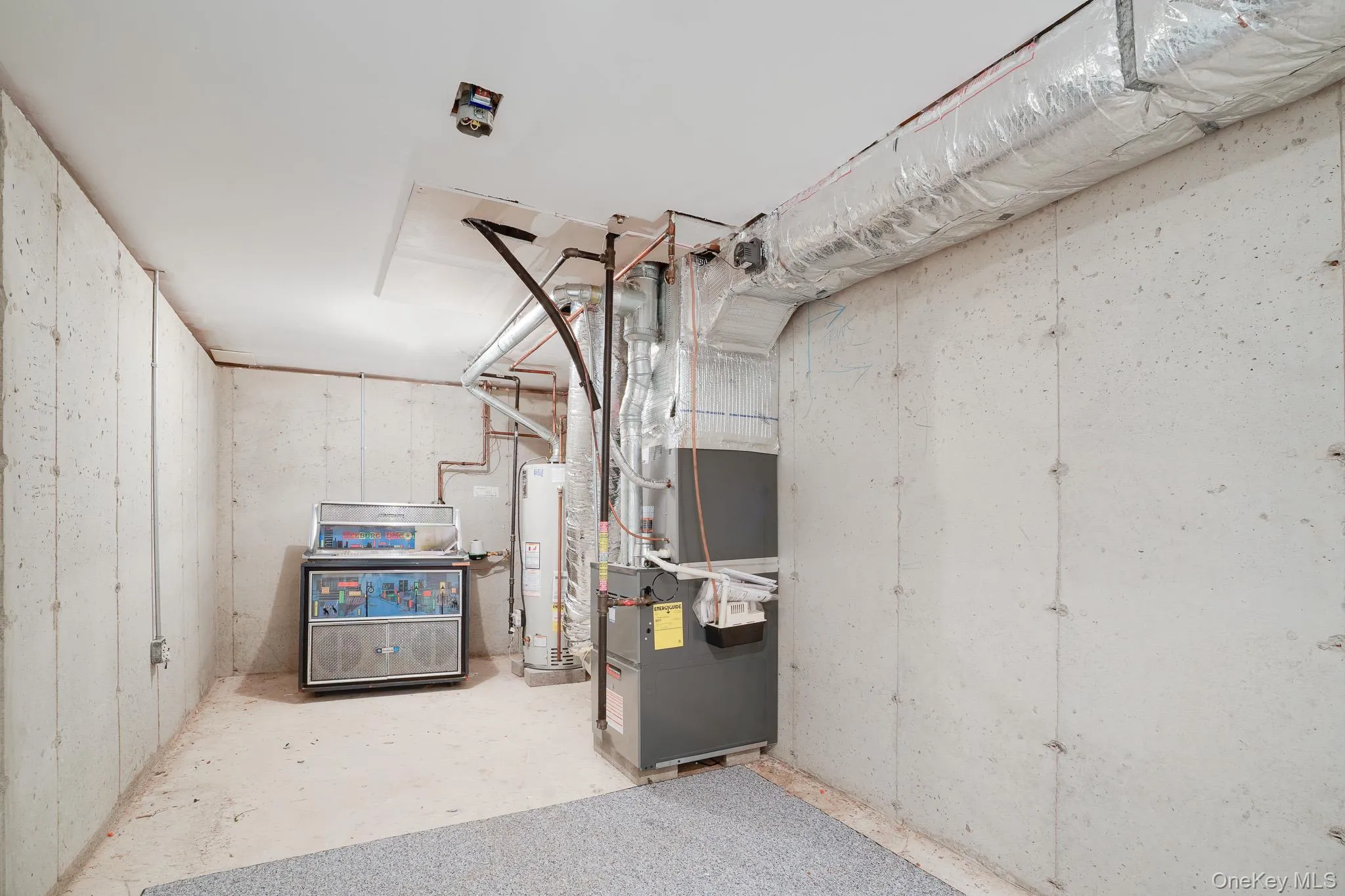 Unfinished basement room featuring mechanicals and storage space Unfinished basement room featuring mechanicals and storage space