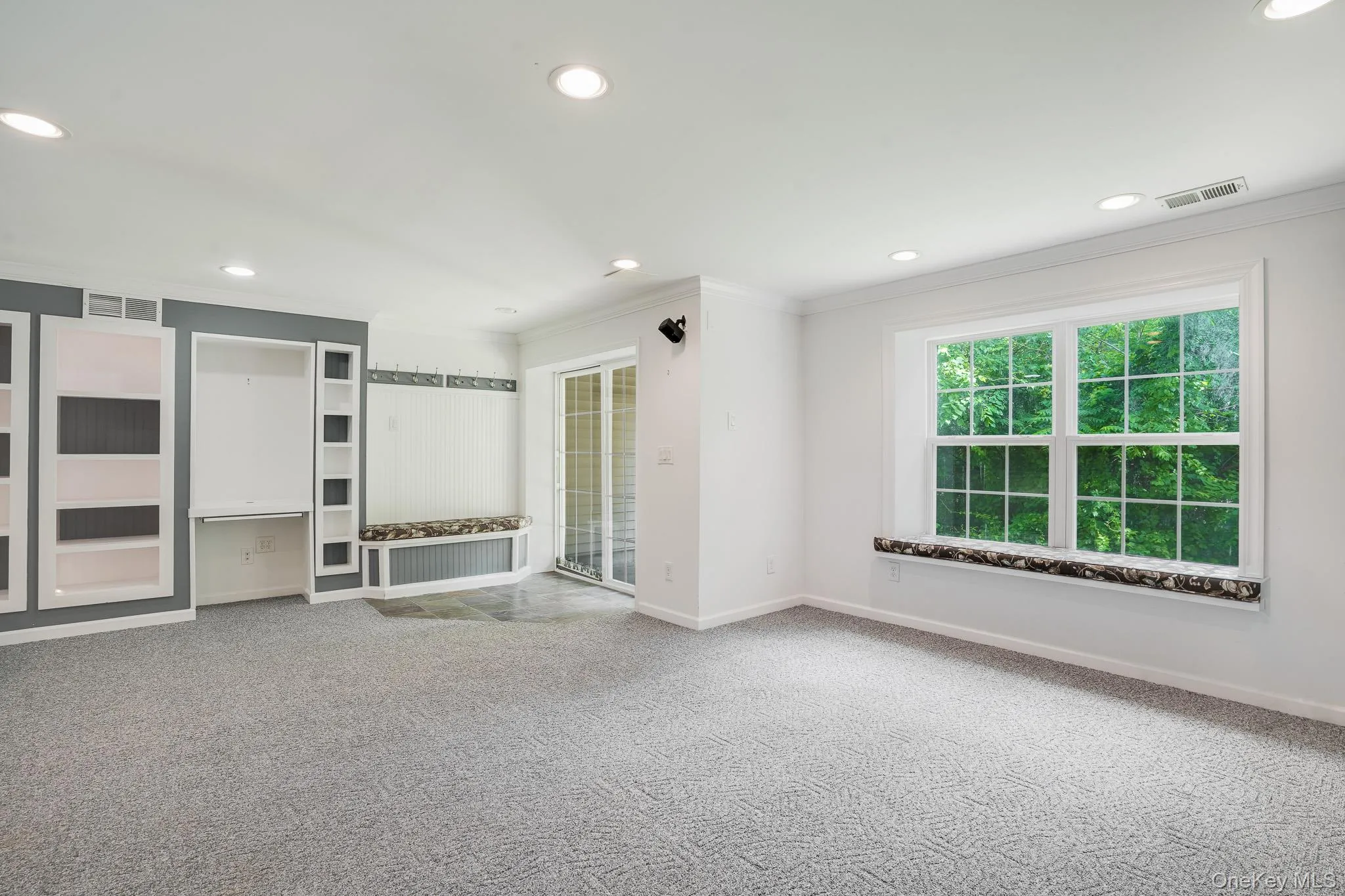 Finished basement area featuring thoughtfully crafted built-ins and recessed lighting Finished basement area featuring thoughtfully crafted built-ins and recessed lighting
