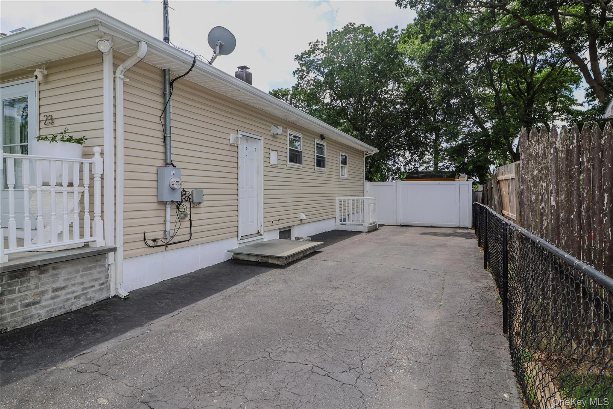 Exterior featuring beige horizontal siding, white trim, and a white railing Exterior featuring beige horizontal siding, white trim, and a white railing