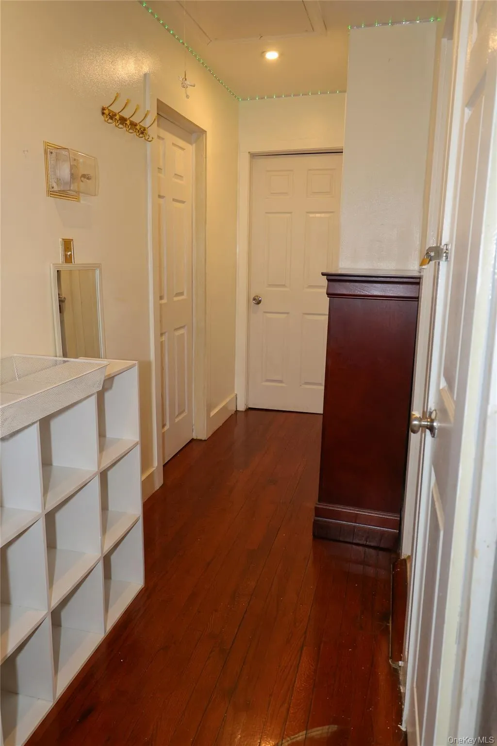 Hardwood-finish flooring extending through the hallway Hardwood-finish flooring extending through the hallway