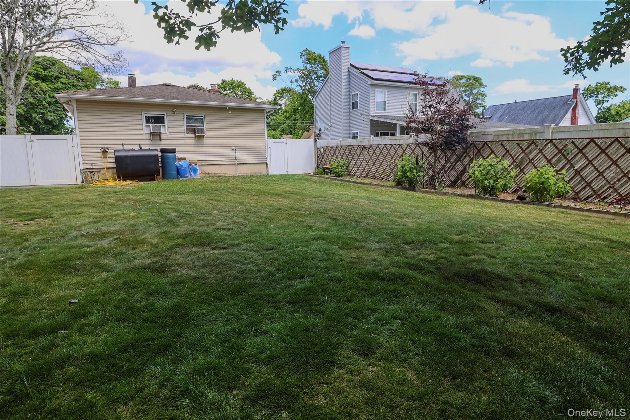 Expansive grassy yard area with perimeter fencing Expansive grassy yard area with perimeter fencing